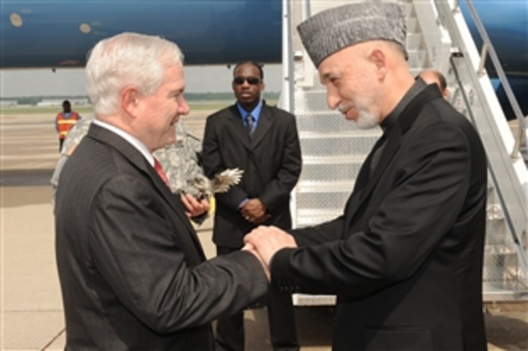 U.S. Defense Secretary Robert M. Gates says goodbye to Afghanistan President Hamid Karzai before the president boards his aircraft at Campbell Army Airfield, Fort Campbell, Ky.,  May 14, 2010. Gates, Karzai and Navy Adm. Mike Mullen, chairmen of the Joint Chiefs of Staff, visited the base so Karzai could thank U.S. troops for their work in Afghanistan.
