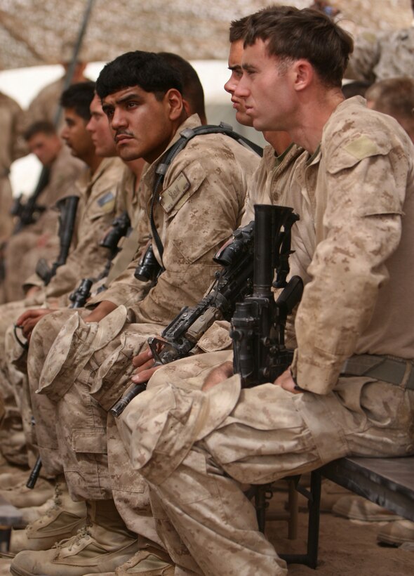 Marines from 3rd Battalion, 6th Marine Regiment, listen to a speaker during the memorial service honoring Lance Cpl. Christopher Rangel at Forward Operating Base Sher Wali, Marjah, Helmand province, Afghanistan, May 16, 2010. Rangel, a rifleman with 1st Platoon, India Company, 3/6, passed away May 6 while conducting combat operations in support of Operation Moshtarak. The service included readings from the Bible, reflections from his fellow Marines, a three-round volley salute and a chance for the Marines and sailors at the event to pay their final respects to Rangel.
