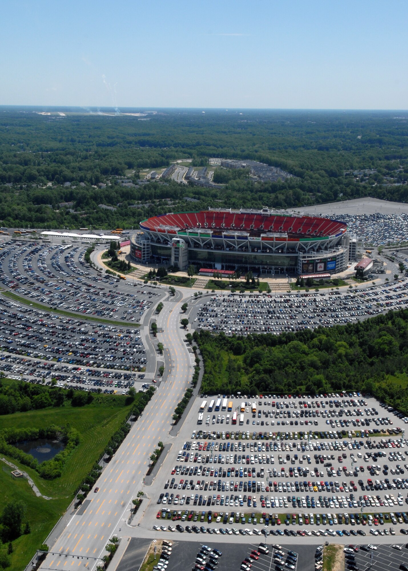JOINT BASE ANDREWS, Md. - Visitors park at FedEx field, home of the NFL Washington Redskins, to attend the opening day of the Joint Service Open House here May 15.  This is the first Joint Service Open House conducted by Team Andrews members at the newly minted Joint Base Andrews, continuing a rich tradition of partnership and strength rooted in service to the nation.  (U.S. Navy photo by Mass Communication Specialist 2nd Class Clifford L. H. Davis)