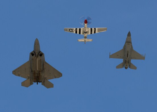 JOINT BASE ANDREWS, Md. - A P-51 Mustang, F-16 Falcon, and F-22 Raptor take part of the U.S. Air Force heritage flight as they fly over the crowd on opening day of the Joint Service Open House here May 15.  This is the first Joint Service Open House conducted by Team Andrews members at the newly minted Joint Base Andrews, continuing a rich tradition of partnership and strength rooted in service to the nation.  (U.S. Navy photo by Mass Communication Specialist 2nd Class Clifford L. H. Davis) 
