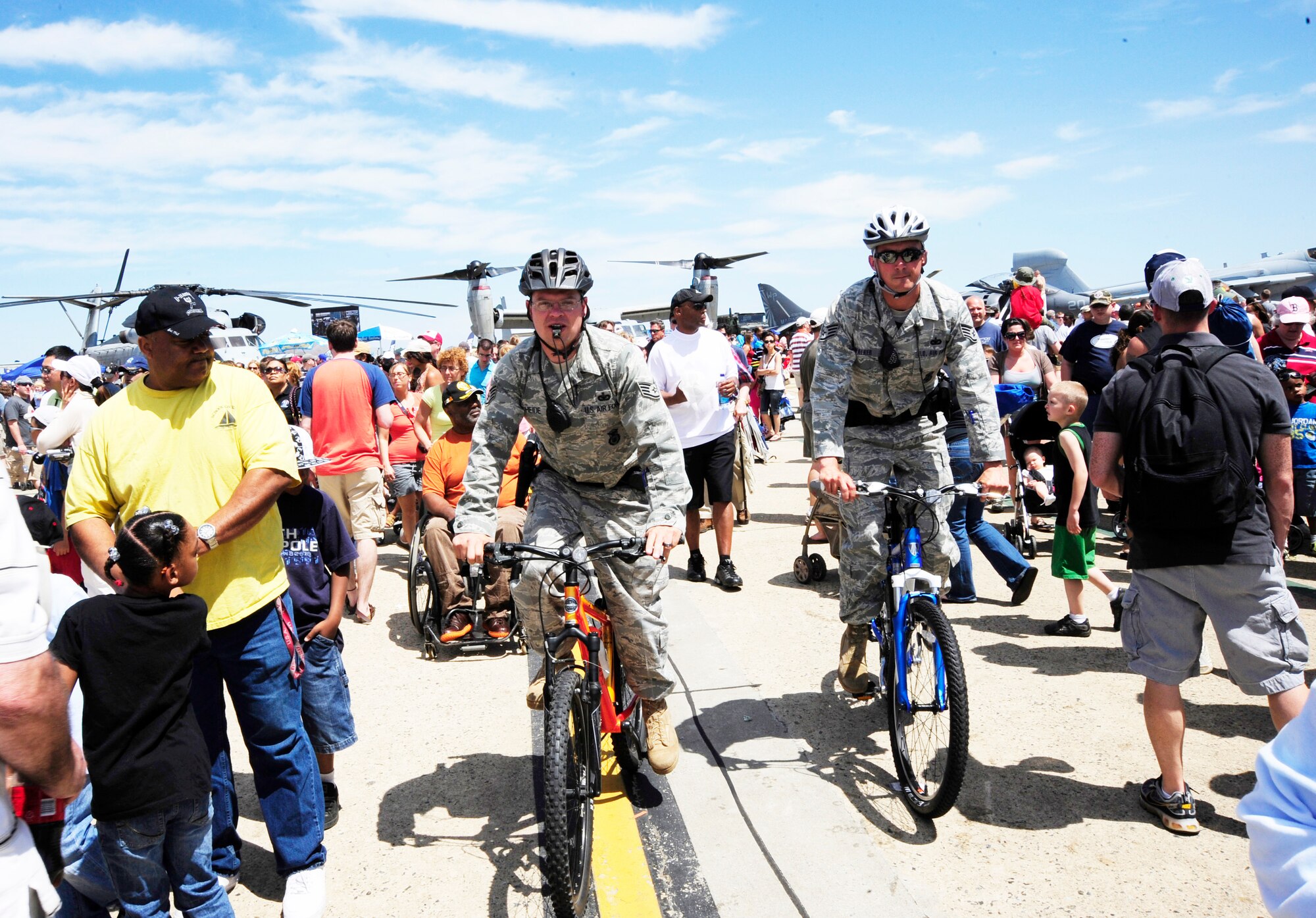 JOINT BASE ANDREWS, Md. - Staff Sergeants Thomas Scheide and Christopher Walker, 316th Security Forces Patrolmen, patrol the crowd on the flightline during the Joint Service Open House here May 15. JSOH allows members of the public an excellent opportunity to meet and interact with the men and women of the Armed Forces. (U.S. Air Force photo by Staff Sgt Keyonna Fennell)