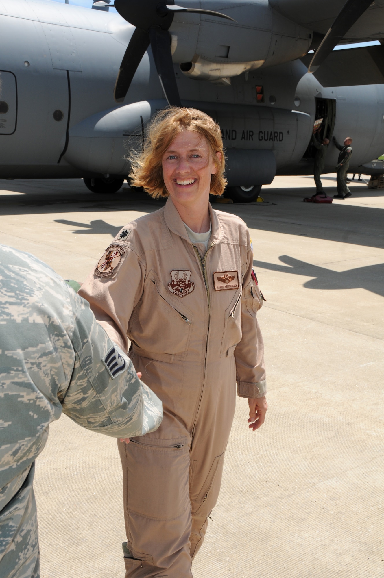 Lt Col. Karen Hendrickson from the 135th Airlift Group of the Maryland Air National Guard receive a welcome on the flightline on Warfield Air National Guard Base, Baltimore, Md., May 15, 2010.  The 135th supported forces fighting in Afghanistan through transporting of supplies and cargo.  (U.S. Air Force photo by Staff Sgt. Benjamin Hughes/ Released) 