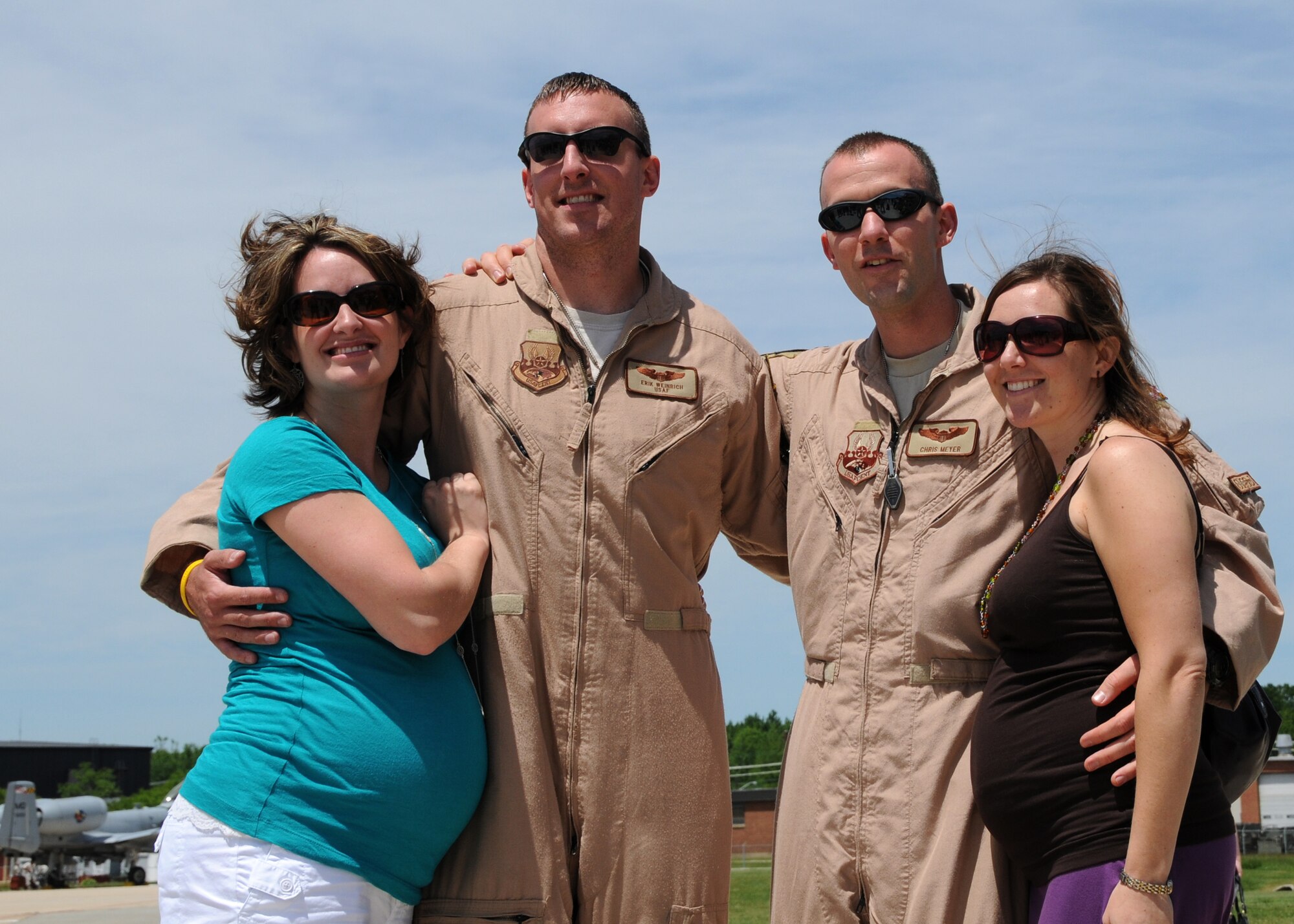 U.S. Air Force Captains Chris Myers and Erik Weinrich , C-130J pilots  with the Maryland Air National Guard, hug their wives, Katie and Holly, on the flightline at Warfield Air National Guard Base, Baltimore, Md., May 15, 2010.  Myers  and Weinrich supported forces fighting in Afghanistan through transporting of supplies and cargo.  (U.S. Air Force photo by Staff Sgt. Benjamin Hughes/Released) 