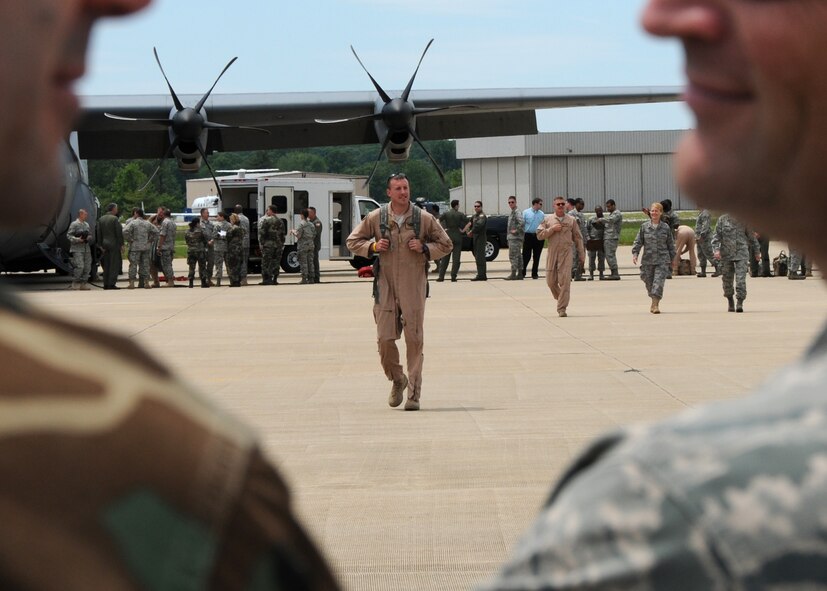 U.S. Air Force Capt. Erik Weinrich of the 135th Airlift Group of the Maryland Air National Guard, walks down the flightline on Warfield Air National Guard Base, Baltimore, Md., May 15, 2010.  Captain Weinrich, a C-130 pilot, supported forces fighting in Afghanistan through transporting of supplies and cargo.  (U.S. Air Force photo by Staff Sgt. Benjamin Hughes/Released) 