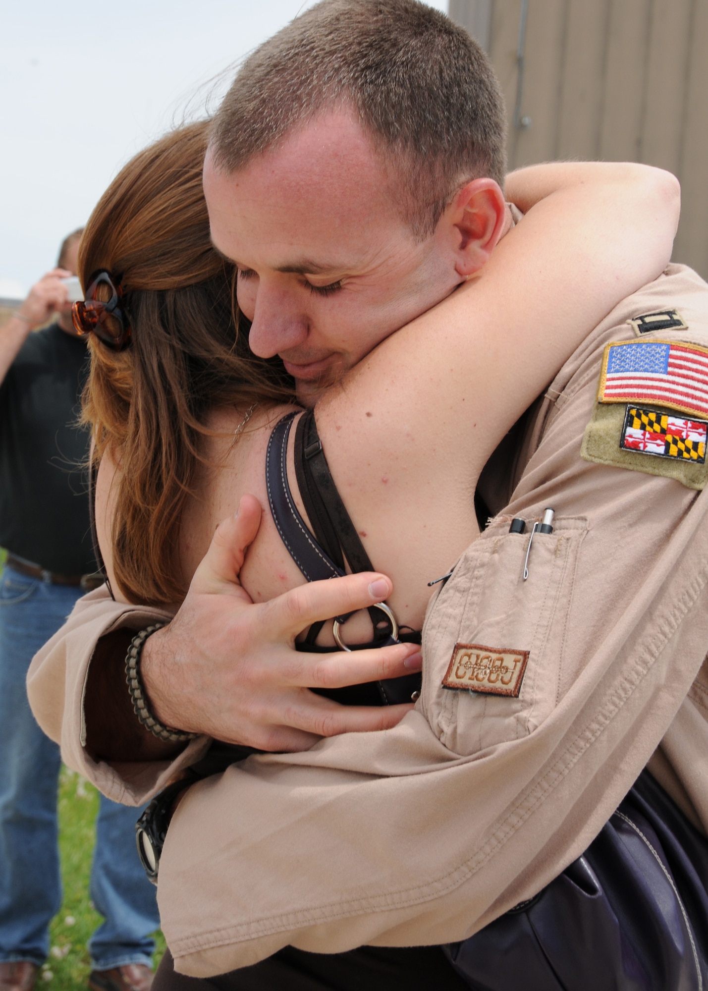 U.S. Air Force Capt. Chris Myers, a C-130J pilot with the Maryland Air National Guard, hugs his wife, Holly, on the flightline on Warfield Air National Guard Base, Baltimore, Md., May 15, 2010.  Captain Myers supported forces fighting in Afghanistan through transporting of supplies and cargo.  (U.S. Air Force photo by Staff Sgt. Benjamin Hughes/Released) 