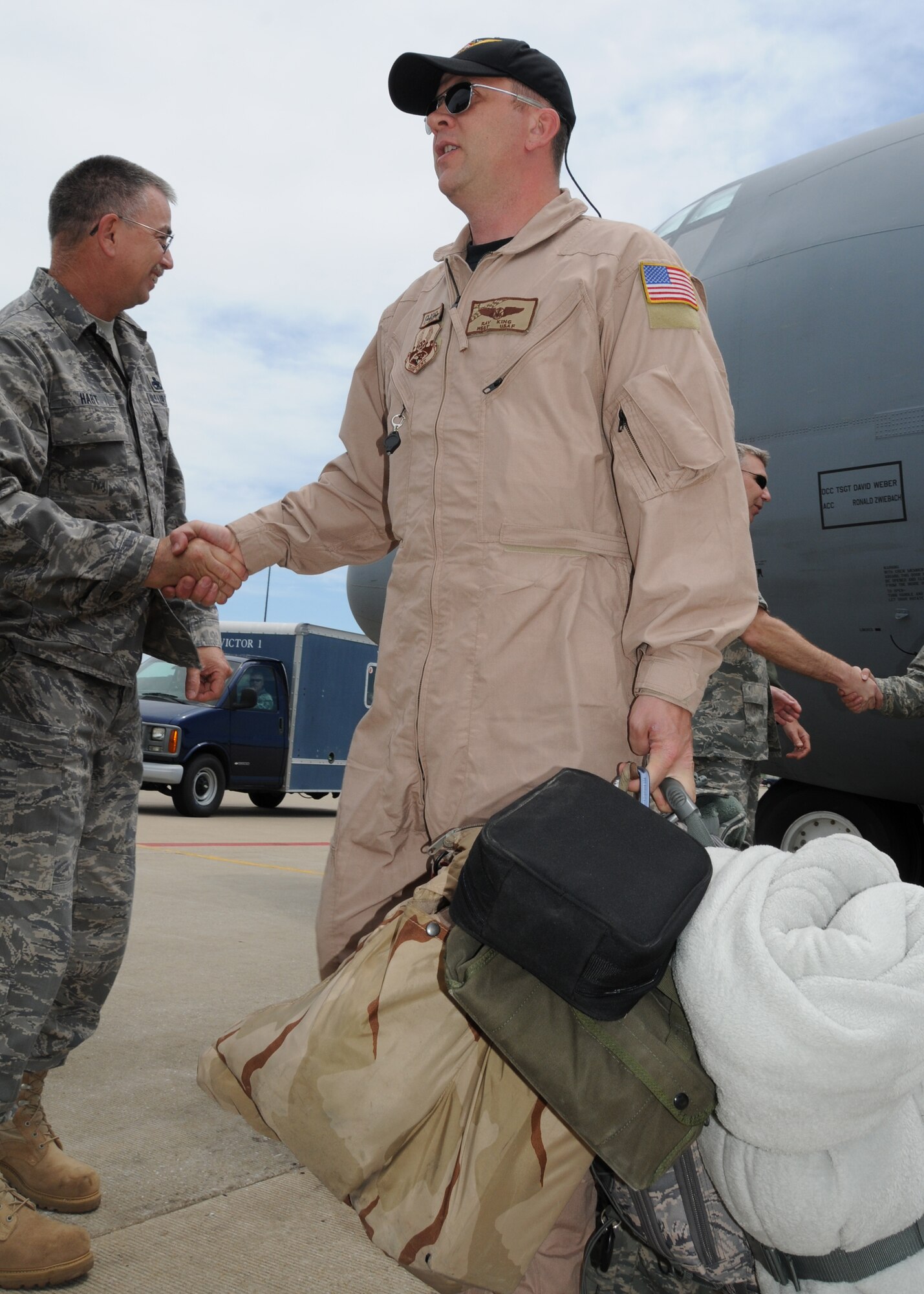 Airmen from the 135th Airlift Group of the Maryland Air National Guard receive a welcome on the flightline on Warfield Air National Guard Base, Baltimore, Md., May 15, 2010.  The 135th supported forces fighting in Afghanistan through transporting of supplies and cargo.  (U.S. Air Force photo by Staff Sgt. Benjamin Hughes/Released) 