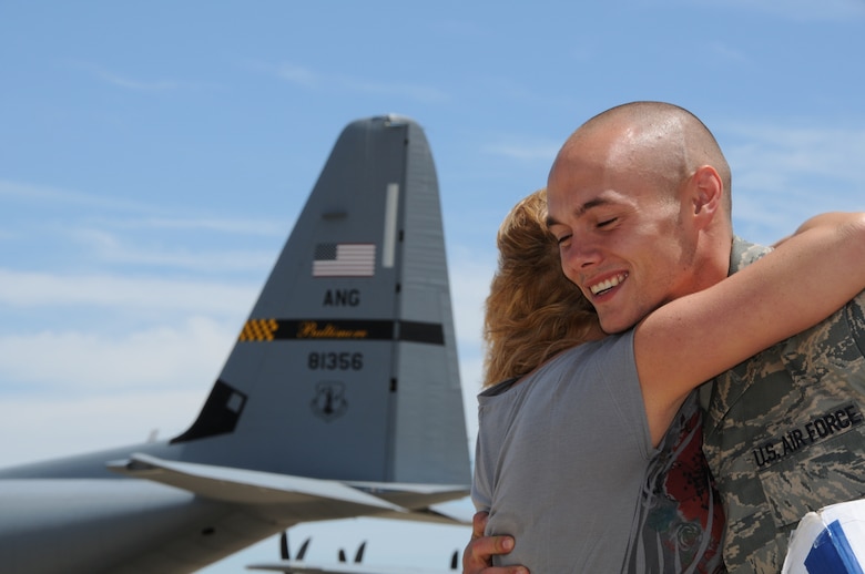 U.S. Air Force Senior Airman Jeff Sanders of the Maryland Air National Guard’s 135th Maintenance Squadron, hugs a family member on the flightline on Warfield Air National Guard Base, Baltimore, Md., May 15, 2010.  Airman Sanders, a C-130J engine mechanic, and the 135th supported forces fighting in Afghanistan through transportation of supplies and cargo.  (U.S. Air Force photo by Staff Sgt. Benjamin Hughes/ Released) 