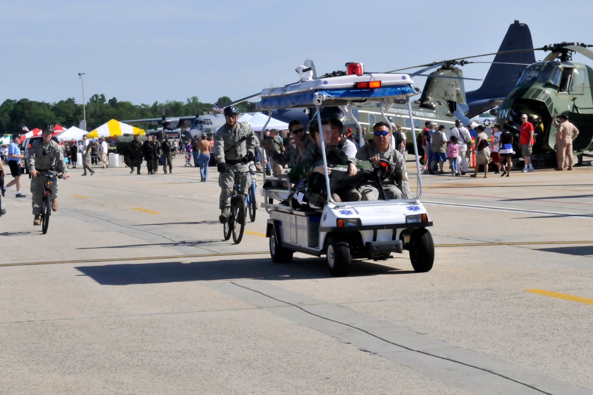 JOINT BASE ANDREWS, Md. - A mobile medical unit from the 779th Medical Group transports a patient to the central medical location in Hangar 4 during the Joint Service Open House here May 15. The 779 MDG offers medical attention with roaming bicyclists, mobile medical units, and ambulances in case of any emergencies should occur. (U.S. Air Force photo by Staff Sgt. Renae L. Saylock)