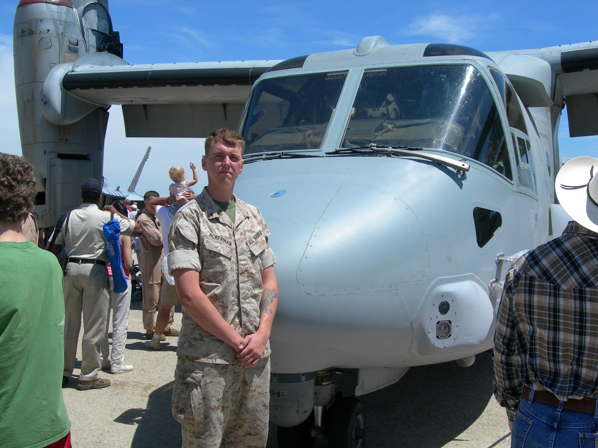 U.S. Marine Lance Cpl. Brandon Ackerman explains the mission roles of the MV-22 to onlookers during the 2010 Joint Service Open House May 15, 2010 held at Joint Base Andrews, Md.  (U.S. Air Force photo by Aletha Frost)