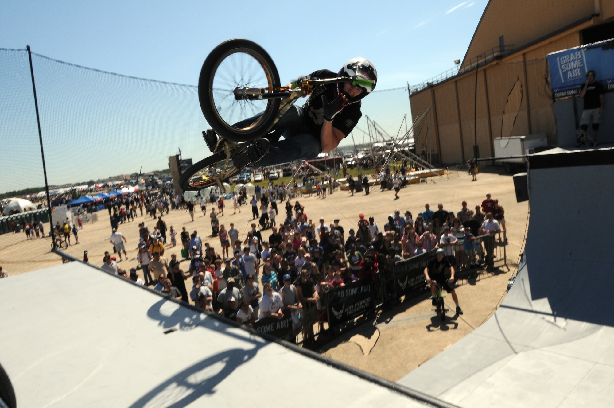JOINT BASE ANDREWS, Md.-- Koji Kraft, a team BMX rider for ASA Entertainment, clears the edge of the ramp at the Joint Service Open House here May 15. Mr. Kraft joins other extreme athletes in supporting the Air Force Reserve recruiting campaign, "Grab Some Air," which aims at attracting an active demographic of 17-34 years old to the Reserve. The JSOH allows members of the public an excellent opportunity to meet and interact with the men and women of the Armed Forces and to show them America’s skilled military. (U.S. Air Force photo by Staff Sgt. Steve Lewis)