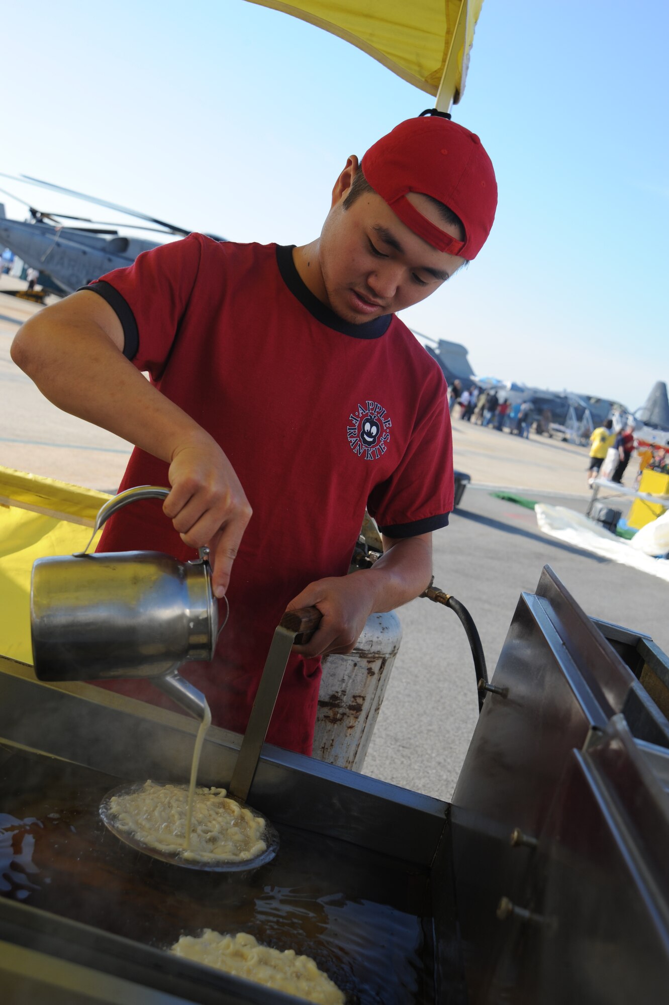 JOINT BASE ANDREWS, Md. -- Andrew Weiser, an employee of Apple Frankies, prepares funnel cakes in the morning hours of the 2010 Joint Service Open House here May 15.  JSOH allows members of the public an excellent opportunity to meet and interact with the men and women of the Armed Forces and to show them America’s skilled military. (U.S. Air Force photo by Staff Sgt. Christopher A. Marasky)
