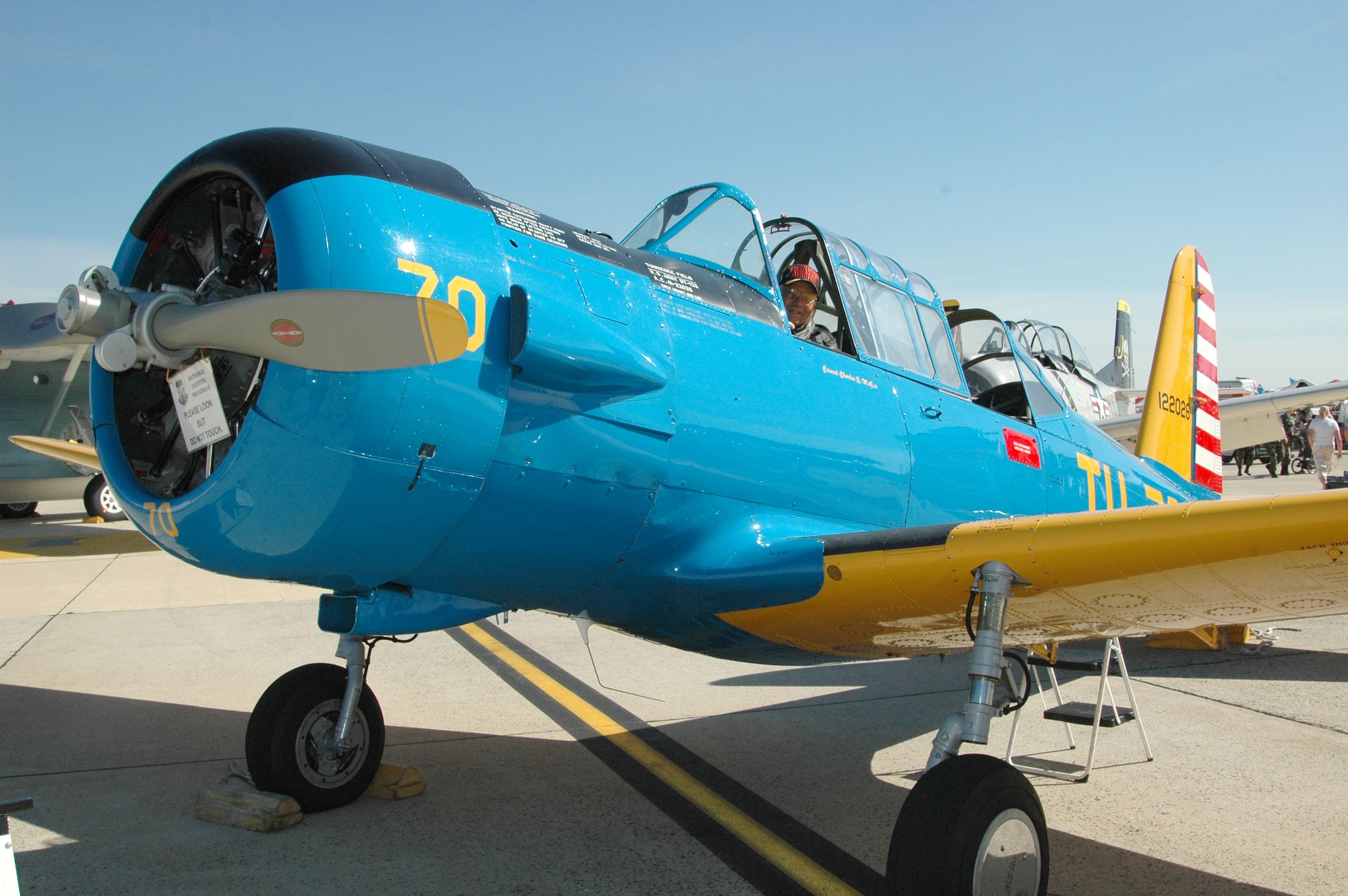 JOINT BASE ANDREWS, Md. - A Tuskegee Airman unveilsa a T-13 replica.
(U.S. Navy photo by Mass Communication Specialist 2nd Class George Trian)