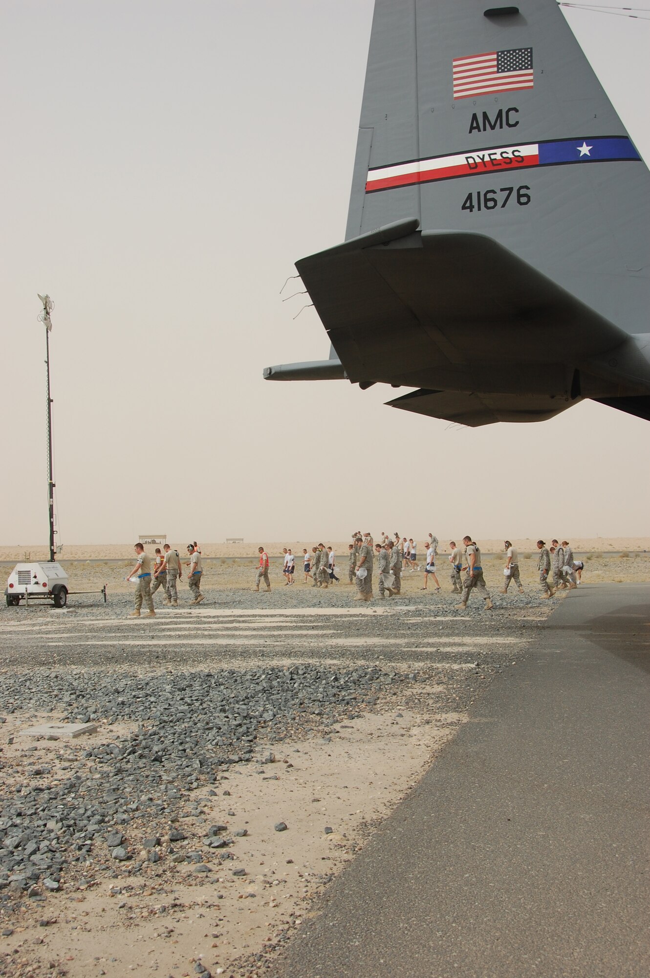 SOUTHWEST ASIA - U.S. Air Force members deployed with the 386th Air Expeditionary Wing conduct a foreign object debris walk on the base airfield here May 15, 2010. Airmen participate in the FOD walk quarterly to ensure trash and other debris remains clear of the airfield to prevent damage to aircraft engines. (U.S. Air Force photo by Staff Sgt. Lakisha A. Croley/Released)