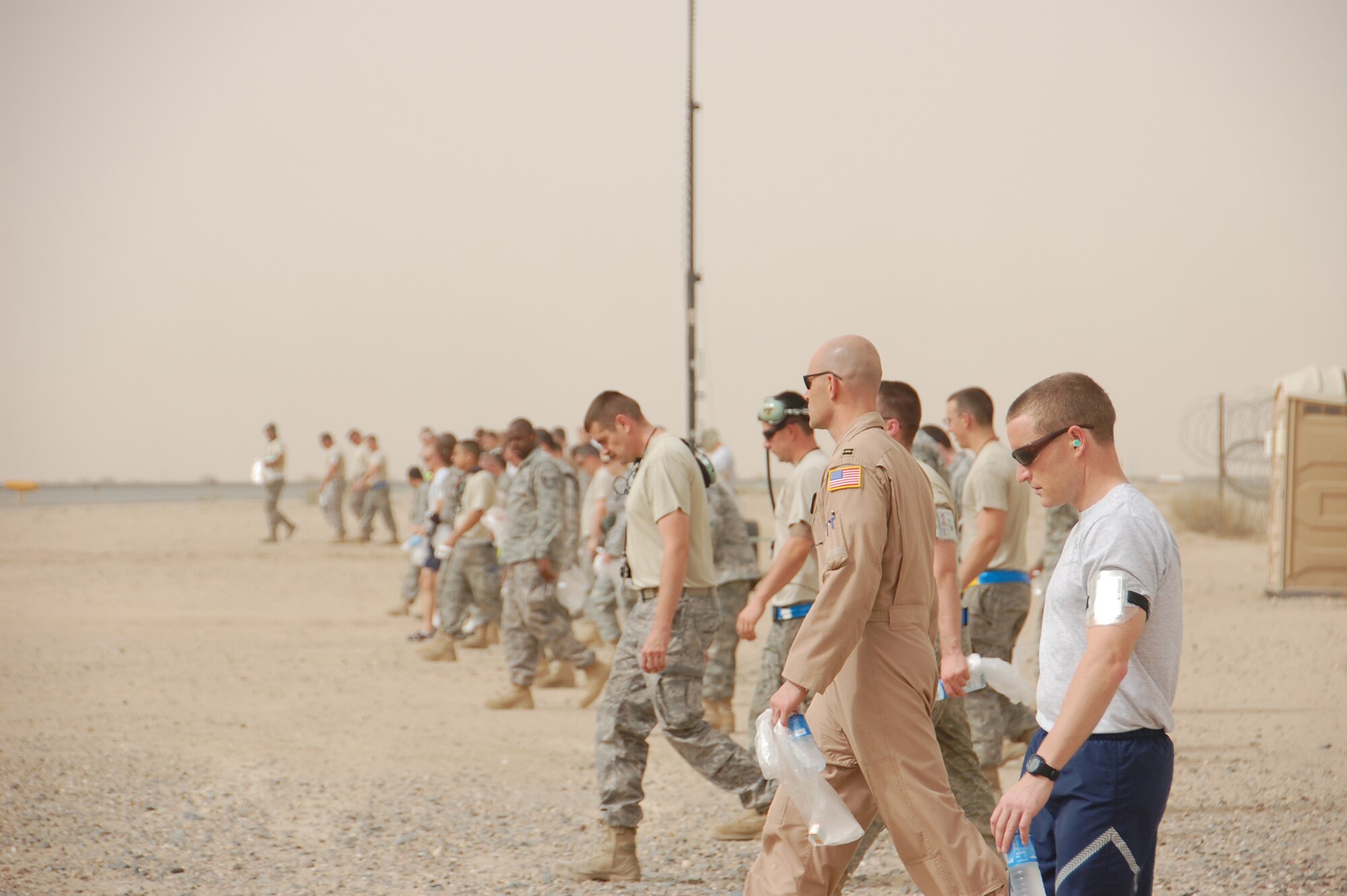 SOUTHWEST ASIA - U.S. Air Force members deployed with the 386th Air Expeditionary Wing conduct a foreign object debris walk on the base airfield here May 15, 2010. Airmen participate in the FOD walk quarterly to ensure trash and other debris remains clear of the airfield to prevent damage to aircraft engines. (U.S. Air Force photo by Staff Sgt. Lakisha A. Croley/Released)