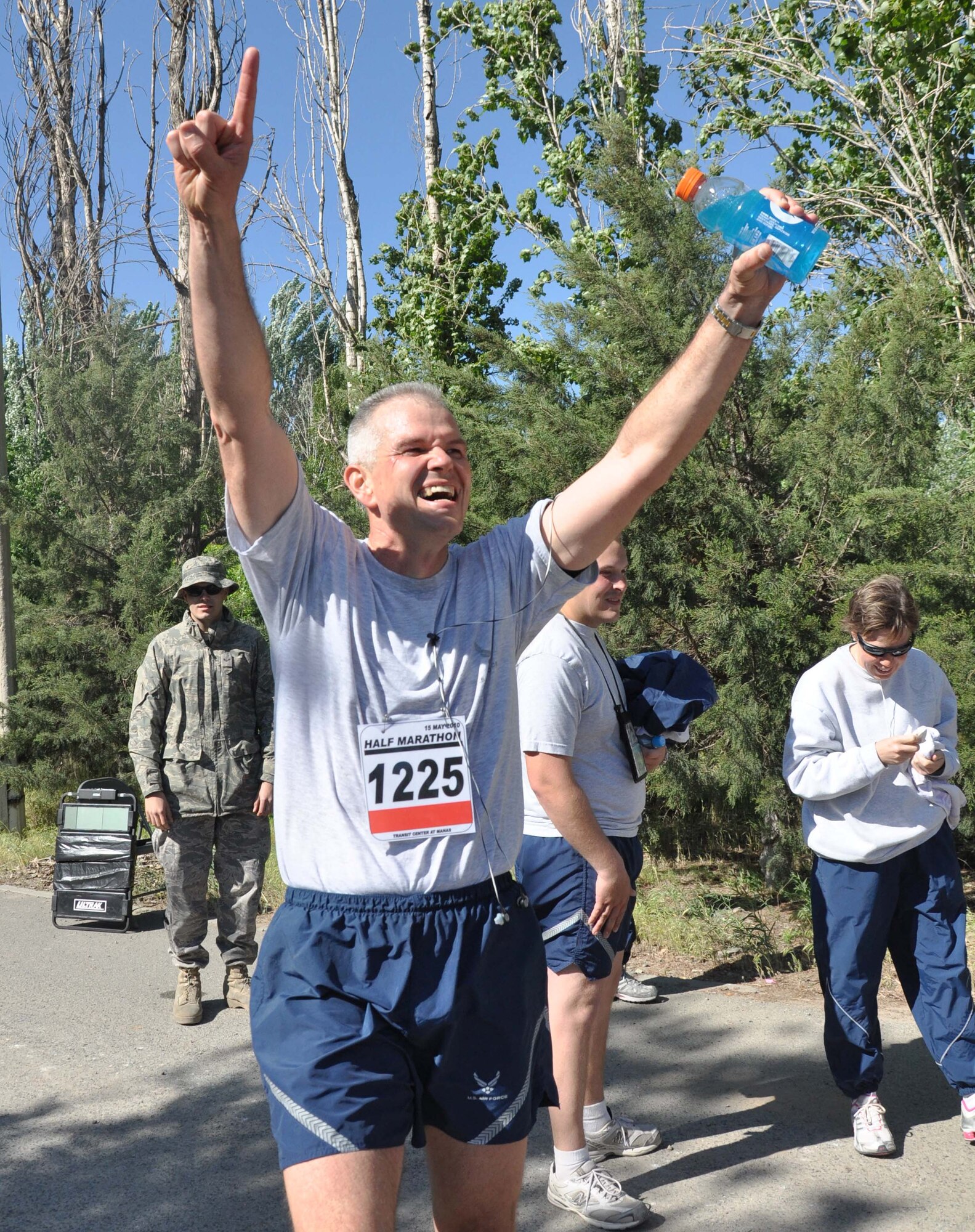 The 376th Expeditionary Force Support Squadron organized a half marathon May 15, 2010, for the Transit Center at Manas, Kyrgyzstan. Several runners relayed, each taking half the run; others finished the full 13.1 miles along a course which bordered the flight line, coming in toward the finish with crowds cheering them on. Airmen, Soldiers, Sailors, Marines, contractors, and Defense Department civilians assigned and transiting through Manas all participated. (U.S. Air Force photo/Staff Sgt. Carolyn Viss)