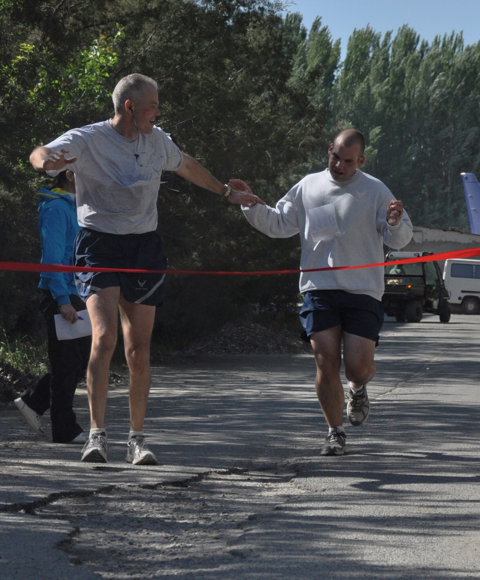 The 376th Expeditionary Force Support Squadron organized a half marathon May 15, 2010, for the Transit Center at Manas, Kyrgyzstan. Several runners relayed, each taking half the run; others finished the full 13.1 miles along a course which bordered the flight line, coming in toward the finish with crowds cheering them on. Airmen, Soldiers, Sailors, Marines, contractors, and Defense Department civilians assigned and transiting through Manas all participated. (U.S. Air Force photo/Staff Sgt. Carolyn Viss)