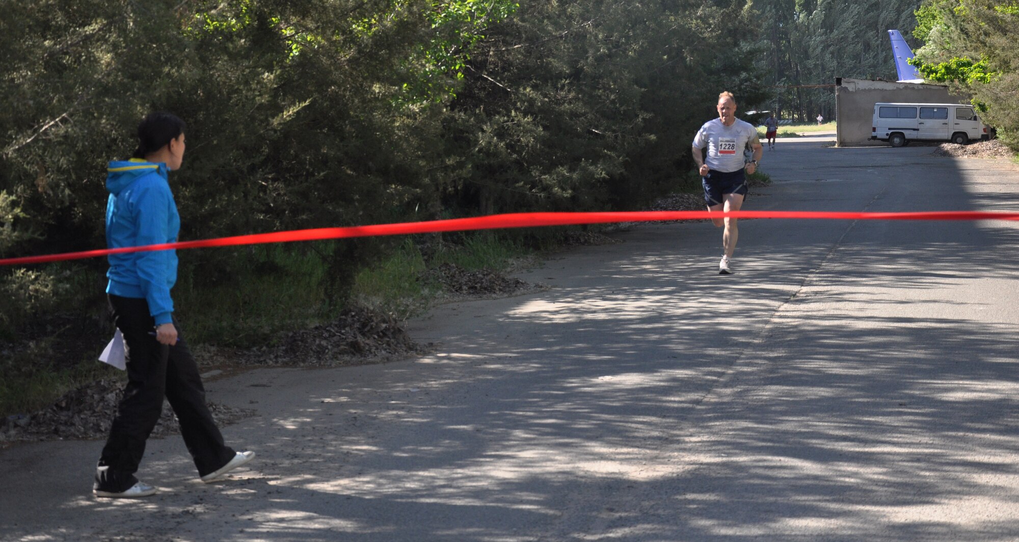 The 376th Expeditionary Force Support Squadron organized a half marathon May 15, 2010, for the Transit Center at Manas, Kyrgyzstan. Several runners relayed, each taking half the run; others finished the full 13.1 miles along a course which bordered the flight line, coming in toward the finish with crowds cheering them on. Airmen, Soldiers, Sailors, Marines, contractors, and Defense Department civilians assigned and transiting through Manas all participated. (U.S. Air Force photo/Staff Sgt. Carolyn Viss)