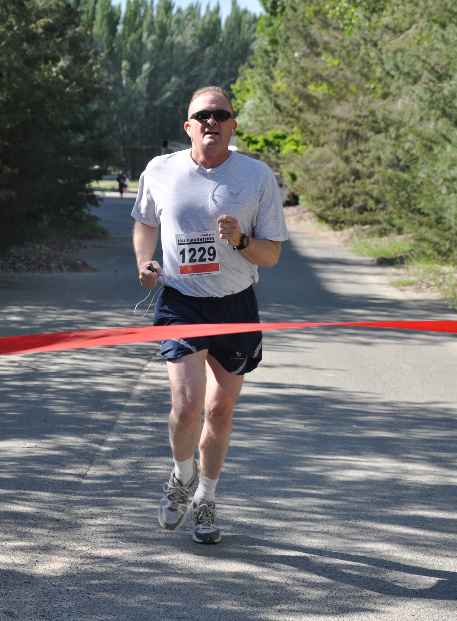 The 376th Expeditionary Force Support Squadron organized a half marathon May 15, 2010, for the Transit Center at Manas, Kyrgyzstan. Several runners relayed, each taking half the run; others finished the full 13.1 miles along a course which bordered the flight line, coming in toward the finish with crowds cheering them on. Airmen, Soldiers, Sailors, Marines, contractors, and Defense Department civilians assigned and transiting through Manas all participated. (U.S. Air Force photo/Staff Sgt. Carolyn Viss)