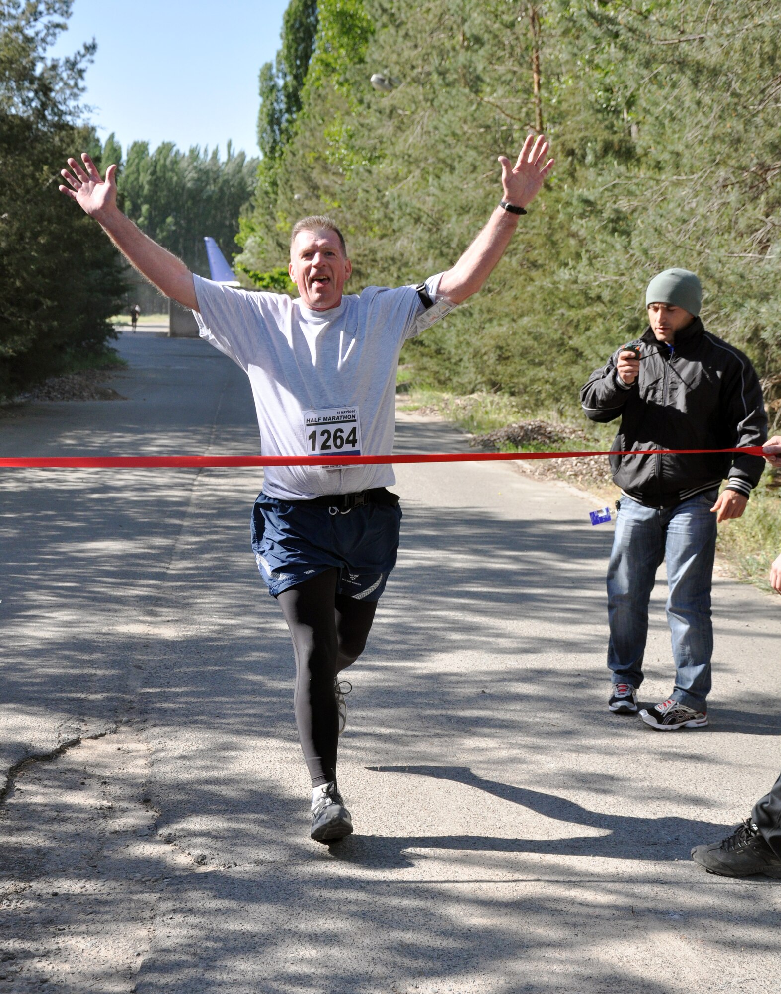 The 376th Expeditionary Force Support Squadron organized a half marathon May 15, 2010, for the Transit Center at Manas, Kyrgyzstan. Several runners relayed, each taking half the run; others finished the full 13.1 miles along a course which bordered the flight line, coming in toward the finish with crowds cheering them on. Airmen, Soldiers, Sailors, Marines, contractors, and Defense Department civilians assigned and transiting through Manas all participated. (U.S. Air Force photo/Staff Sgt. Carolyn Viss)