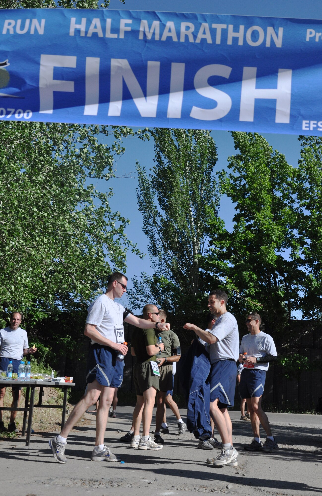 The 376th Expeditionary Force Support Squadron organized a half marathon May 15, 2010, for the Transit Center at Manas, Kyrgyzstan. Several runners relayed, each taking half the run; others finished the full 13.1 miles along a course which bordered the flight line, coming in toward the finish with crowds cheering them on. Airmen, Soldiers, Sailors, Marines, contractors, and Defense Department civilians assigned and transiting through Manas all participated. (U.S. Air Force photo/Staff Sgt. Carolyn Viss)