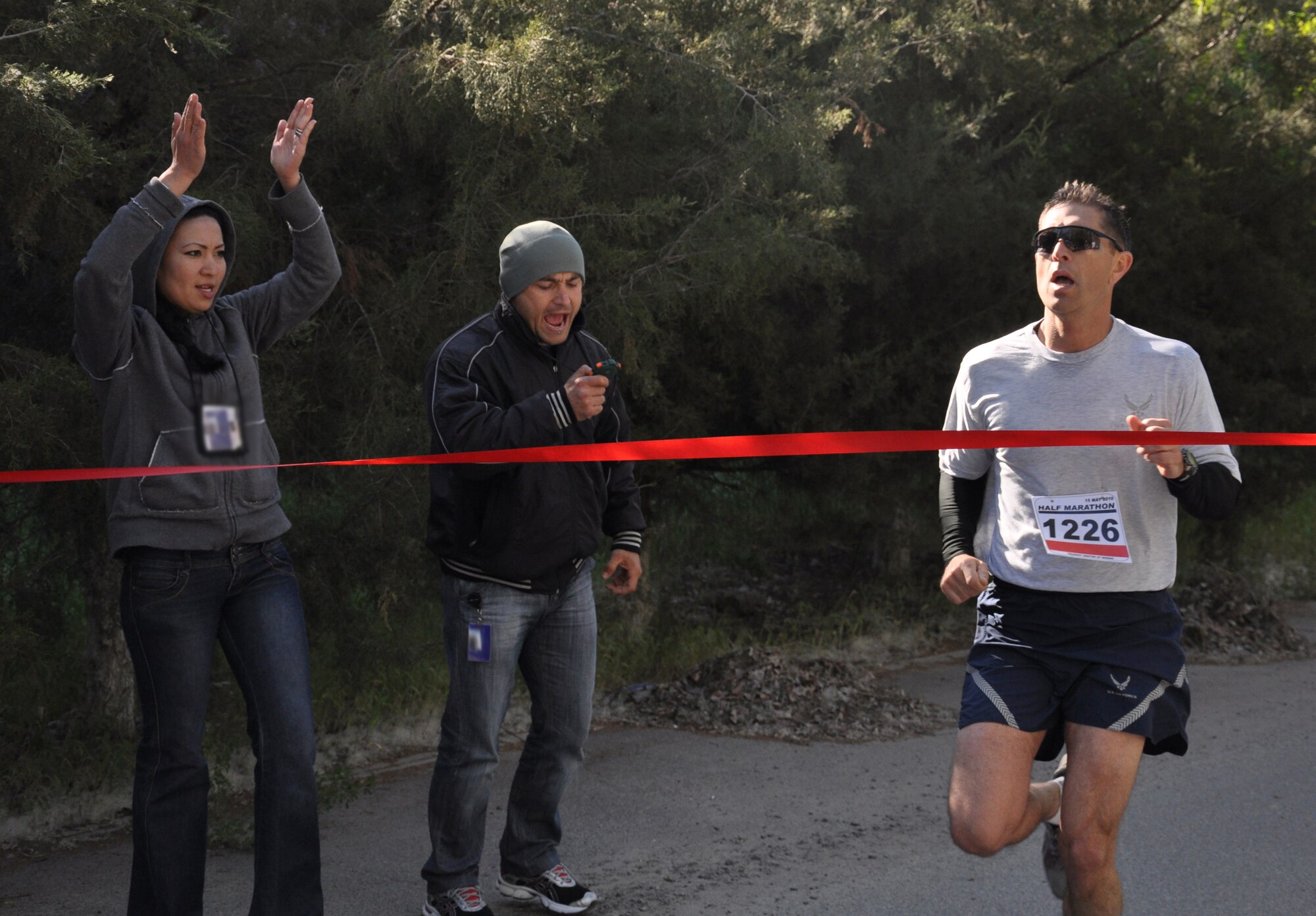 The 376th Expeditionary Force Support Squadron organized a half marathon May 15, 2010, for the Transit Center at Manas, Kyrgyzstan. Several runners relayed, each taking half the run; others finished the full 13.1 miles along a course which bordered the flight line, coming in toward the finish with crowds cheering them on. Airmen, Soldiers, Sailors, Marines, contractors, and Defense Department civilians assigned and transiting through Manas all participated. (U.S. Air Force photo/Staff Sgt. Carolyn Viss)