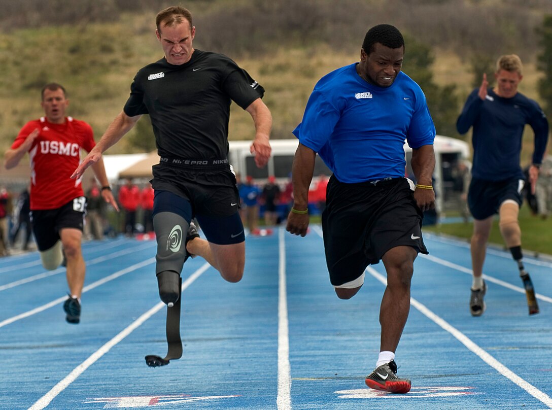 Air Force Staff Sgt. Elmer Sanders crosses the finish line ahead of the three other service members during the track and field event at the Warrior Games May at the Olympic Training Center, Colorado Springs, Colo., May 14, 2010.