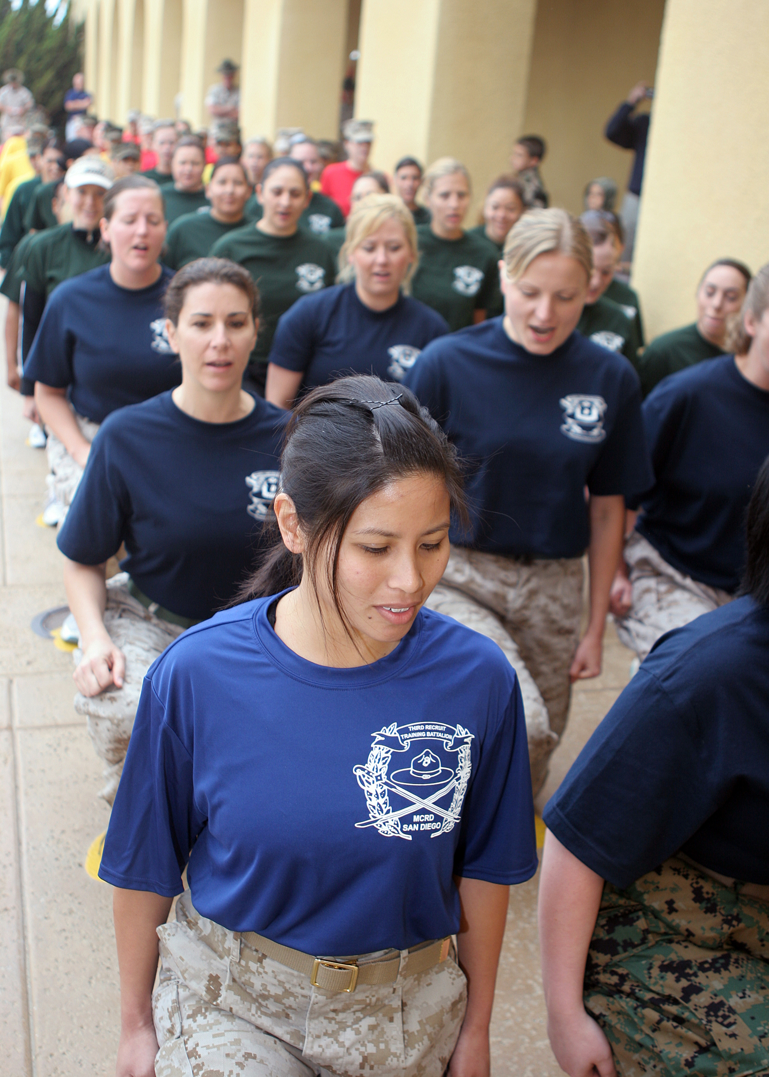 Marine spouses line up on the infamous yellow footprints before recieving their initial brief  during Marine Corps Recruit Depot San Diego's Jayne Wayne Day, May 15. During Jayne Wayne Day, spouses learned close order drill, conquered the Confidence Course, fired at the Indoor Simulated Marksmanship Trainer and descended from the depot's 50-foot rappel tower. Jayne Wayne Day gives Marine spouses a first-hand look at what their loved ones do on a daily basis and allows them to experience not only the physical and mental challenges, but also the camaraderie.