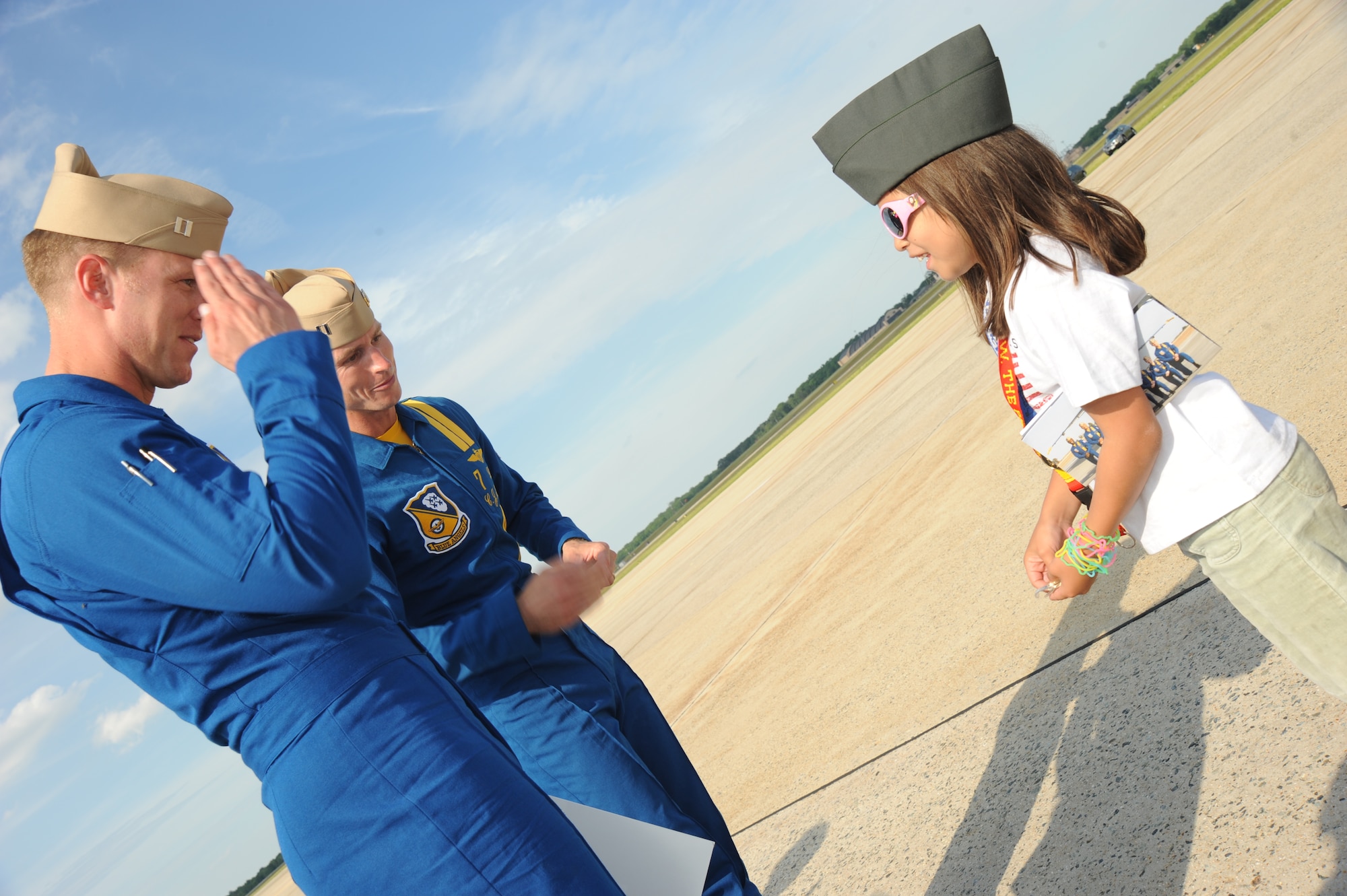 JOINT BASE ANDREWS, Md. - Lt. Ben Walborn (front) and Lt. C.J. Simonson, members of the Navy Blue Angels team, receive coins from Rizzy Wieser, a nine year-old girl who traveled from Florida to say thank you to service members at the Joint Service Open House here May 16. JSOH allows members of the public an excellent opportunity to meet and interact with the men and women of the Armed Forces. (U.S. Air Force photo by Staff Sgt. Christopher Marasky)
