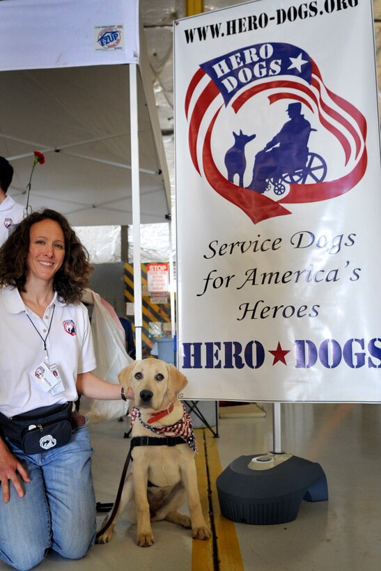 JOINT BASE ANDREWS, Md. - Jennifer Lund, president and founder of the Hero Dog, Inc., poses with Lady Liberty, Libby, a service dog in training, at the Joint Service Open House here May 16. Hero Dog, Inc. is a new charity organization that started training dogs for veterans in need of assistance. (U.S. Air Force photo by Staff Sgt. Renae L. Saylock)