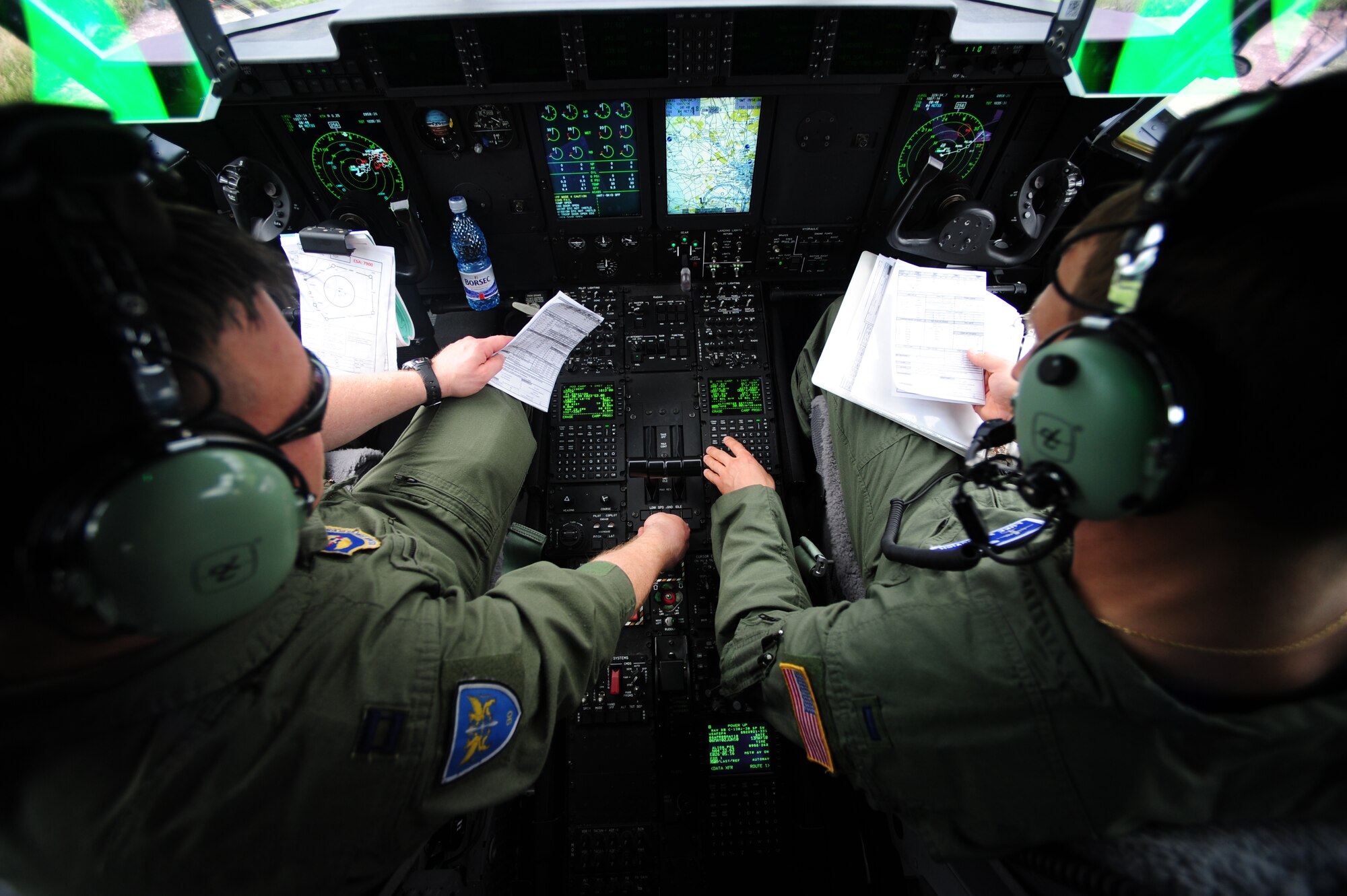 U.S. Air Force Capt. Scott Zwiers and 1st Lt. Luke Wascovich, 37th Airlift Squadron, go though pre-flight procedures in a C-130J, during Carpathian Summer 2010, Otopeni Airlift Base, Romania, May 13, 2010. Carpathian Summer 2010 was an exercise in which the Romanian Air Force invited members of the U.S. military to train with them on their soil and air space, to observe and practice, firsthand, operations in action. This exercise was designed to build partnerships between these nations in an effort to work together more efficiently during real world scenarios. (U.S. Air Force Photo by Staff Sgt. Jocelyn Rich)