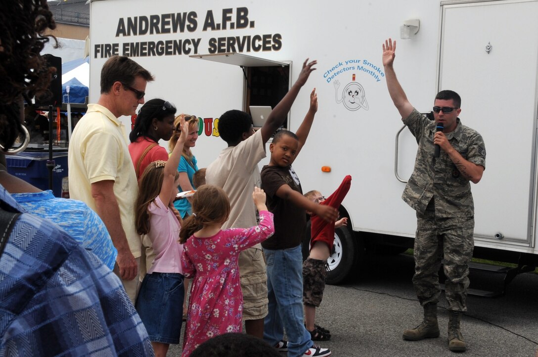 Joint Base Andrews, Md. – Air Force Staff Sgt Bryan Hoover, 316 Civil Engineering Squadron fire fighter/inspector, prepares a crowd of visitors to enter the fire department’s smoke house during Joint Service Open House here May 16. JSOH offers an opportunity for service members to interact with, thank and show the public America’s skilled military. (U.S Air Force photo by Senior Airman Melissa V. Brownstein)
