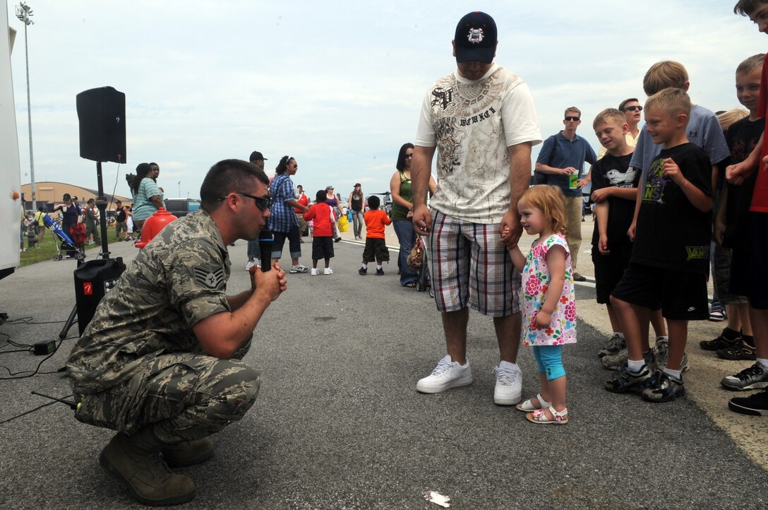 Joint Base Andrews, Md. – Air Force Staff Sgt Bryan Hoover, 316 Civil Engineering Squadron fire fighter/inspector, prepares a young child and her father to enter the fire department’s smoke house during Joint Service Open House here May 16. The smoke house is designed to show people what it is like when there is a fire. It is one of many interactive displays at JSOH. (U.S Air Force photo by Senior Airman Melissa V. Brownstein)