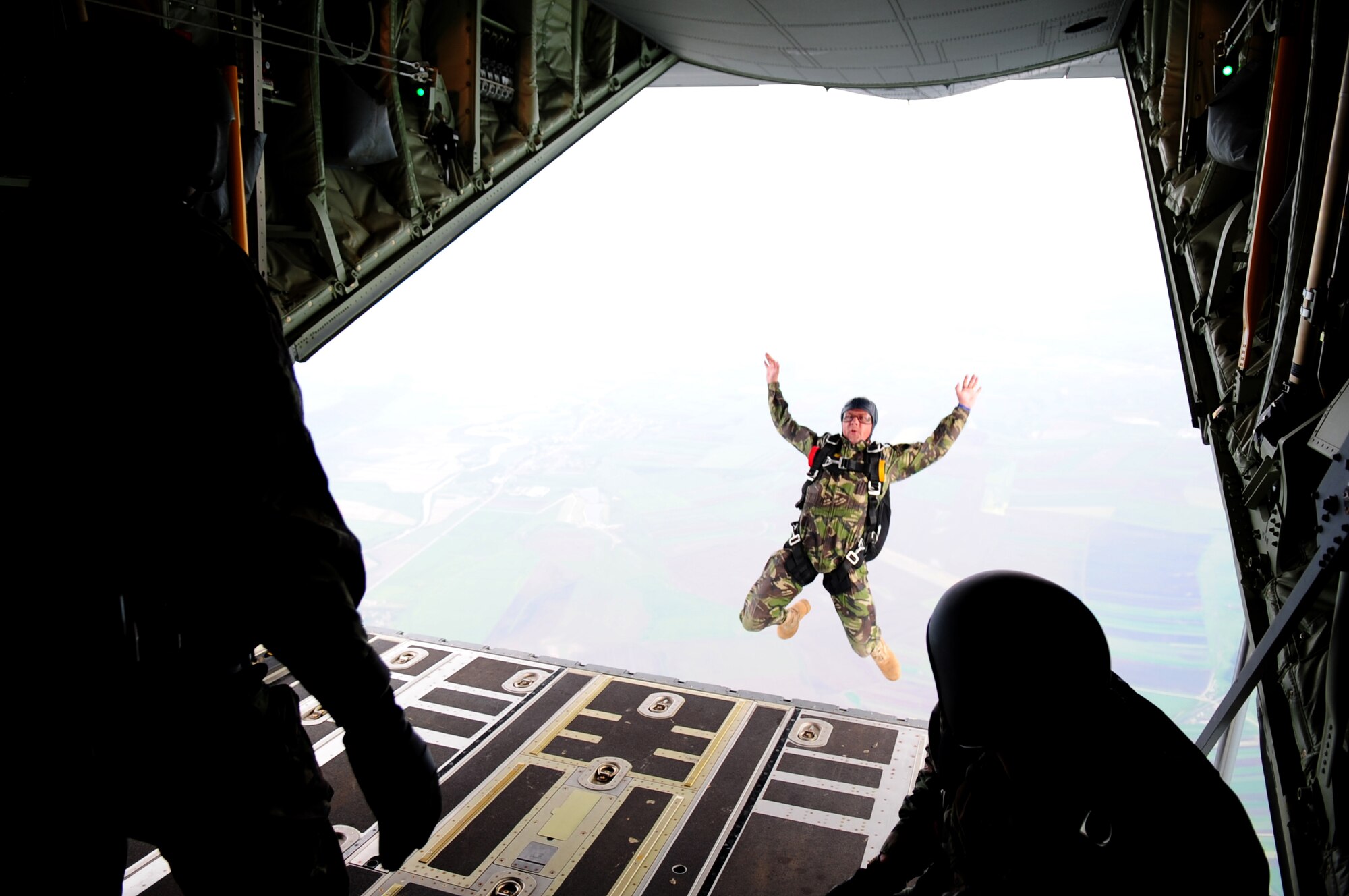 A Romanian Air Force free-fall paratrooper exits from a U.S. Air Force C-130J during exercise Carpathian Summer, Camp Turzii, Romania, May 13, 2010. Carpathian Summer 2010 was an exercise in which the Romanian Air Force invited members of the U.S. military to train with them on their soil and air space, to observe and practice, firsthand, operations in action. This exercise was designed to build partnerships between these nations in an effort to work together more efficiently during real world scenarios. (U.S. Air Force Photo by Staff Sgt. Jocelyn Rich)