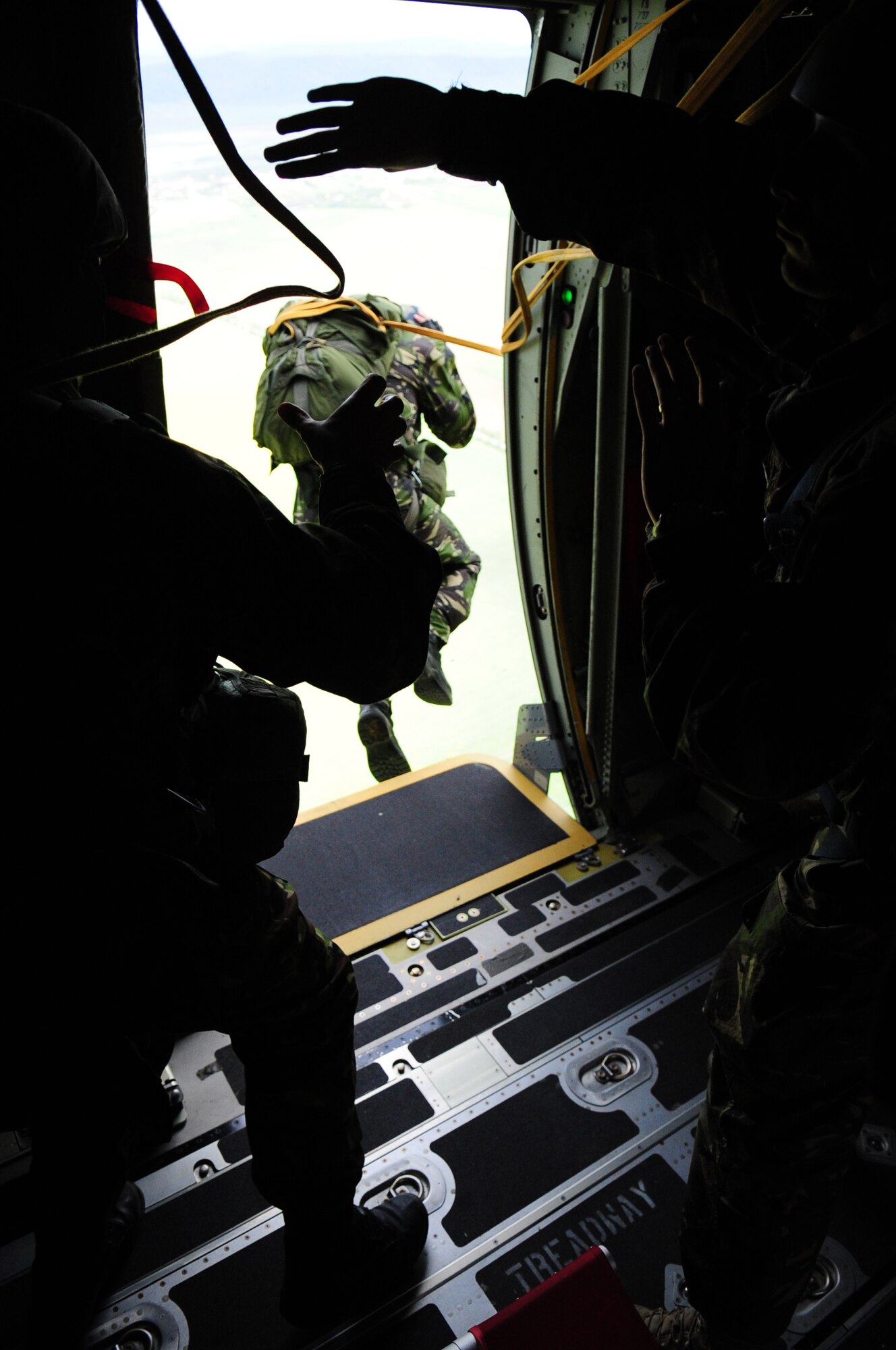 A Romanian Air Force paratrooper exits the side door of a U.S. Air Force C-130J, during exercise Carpathian Summer, Camp Turzii, Romania, May 13, 2010. Carpathian Summer 2010 was an exercise in which the Romanian Air Force invited members of the U.S. military to train with them on their soil and air space, to observe and practice, firsthand, operations in action. This exercise was designed to build partnerships between these nations in an effort to work together more efficiently during real world scenarios. (U.S. Air Force Photo by Staff Sgt. Jocelyn Rich)