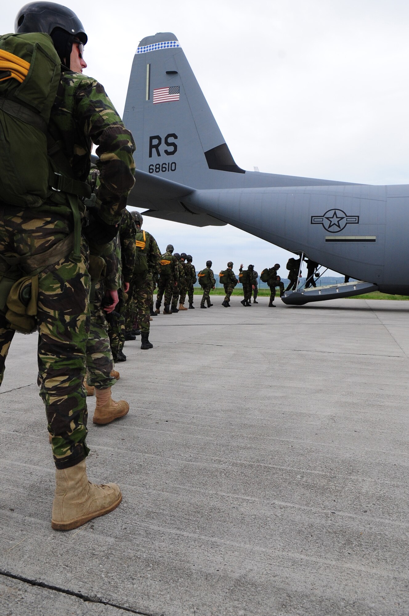 Romanian paratroopers board a U.S. Air Force C-130J in preparation for a jump during exercise Carpathian Summer, Camp Turzii, Romania, May 13, 2010. Carpathian Summer 2010 was an exercise in which the Romanian Air Force invited members of the U.S. military to train with them on their soil and air space, to observe and practice, firsthand, operations in action. This exercise was designed to build partnerships between these nations in an effort to work together more efficiently during real world scenarios. (U.S. Air Force Photo by Staff Sgt. Jocelyn Rich)