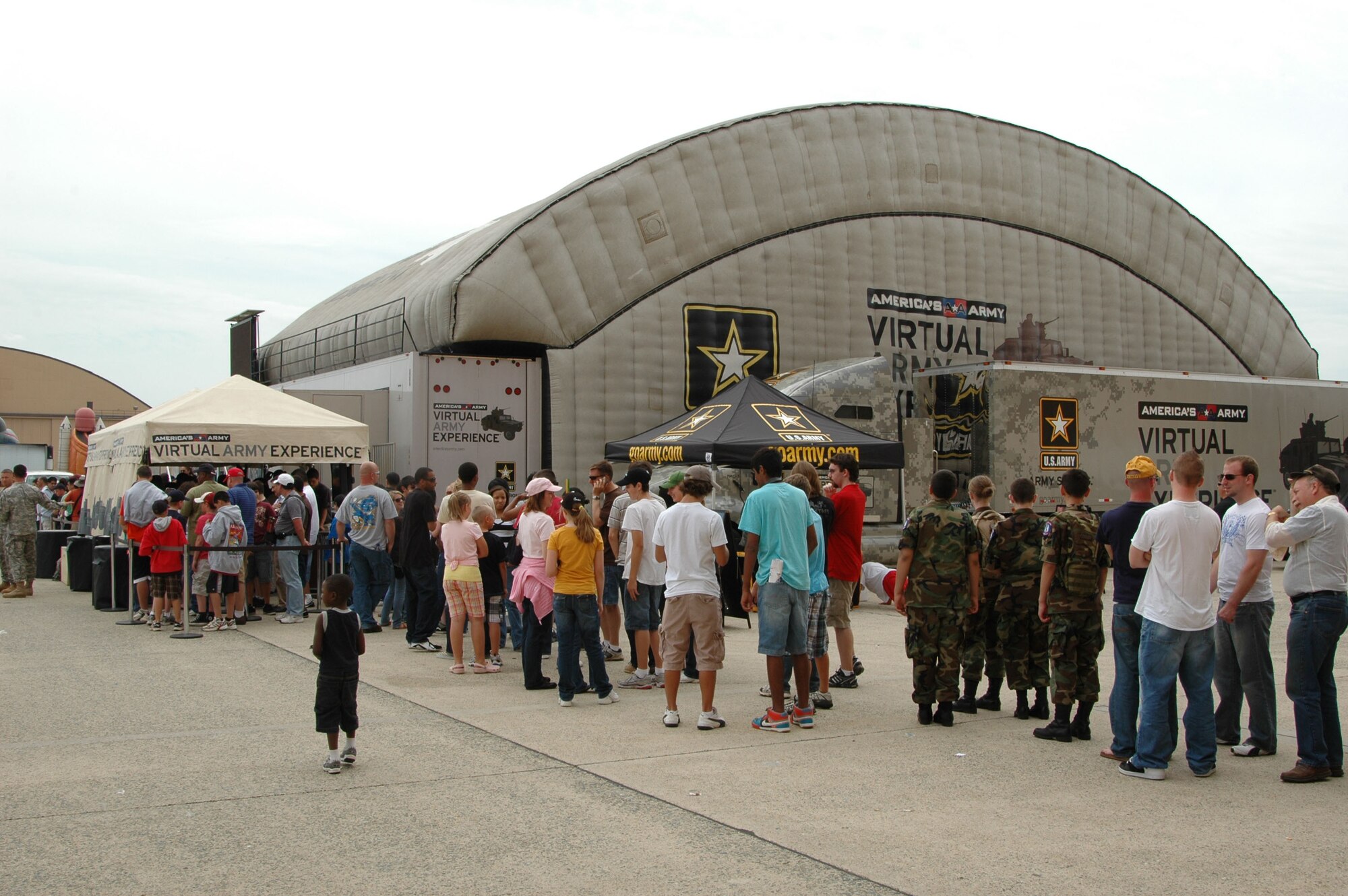 The line for the Virtual Army Experience tour seems to be forever as visitors stand in line watiing the opportunity to the tour the VAE May 15, 2010 at the 2010 Joint Service Open House at Joint Base Andrews, Md.  The VAE is expected to have 2,100 visitors by the close of the 3-day event. (U.S. Air Force photo by Aletha Frost) 
