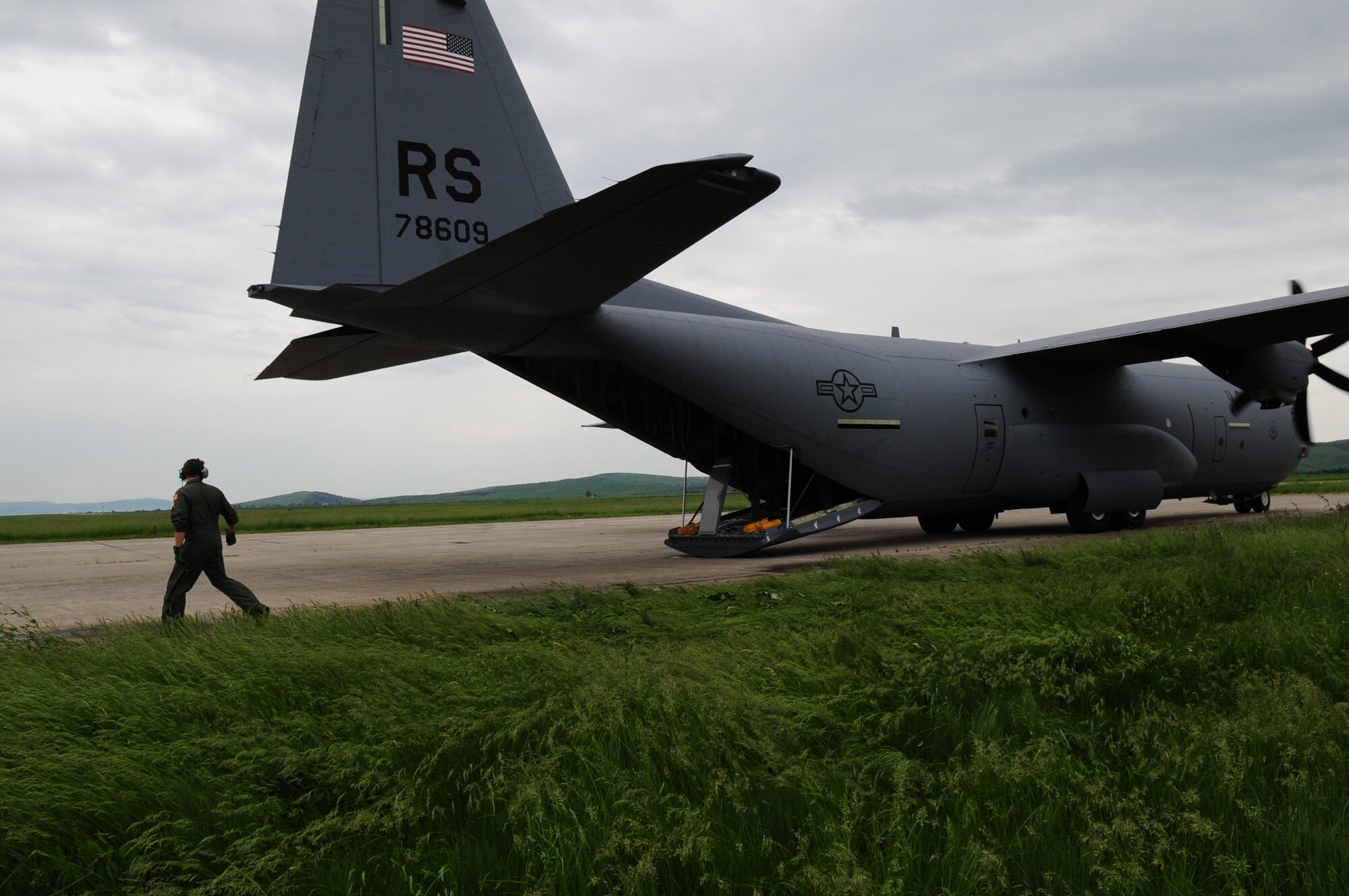 U.S. Air Force Tech. Sgt. David Dais, 37th Airlift Squadron loadmaster, provides wing guidance to a U.S. Air Force C-130J Hercules as it taxis on the flightline of Camp Turzii, Romania, May 13, 2010. The C-130J, its crew and other members of the U.S. Air Force and Navy have landed at Turzii to pick up Romanian paratroopers for a jump during exercise Carpathian Summer. Carpathian Summer 2010 was an exercise in which the Romanian Air Force invited members of the U.S. military to train with them on their soil and air space, to observe and practice, firsthand, operations in action. This exercise was designed to build partnerships between these nations in an effort to work together more efficiently during real world scenarios. (U.S. Air Force Photo by Staff Sgt. Jocelyn Rich)