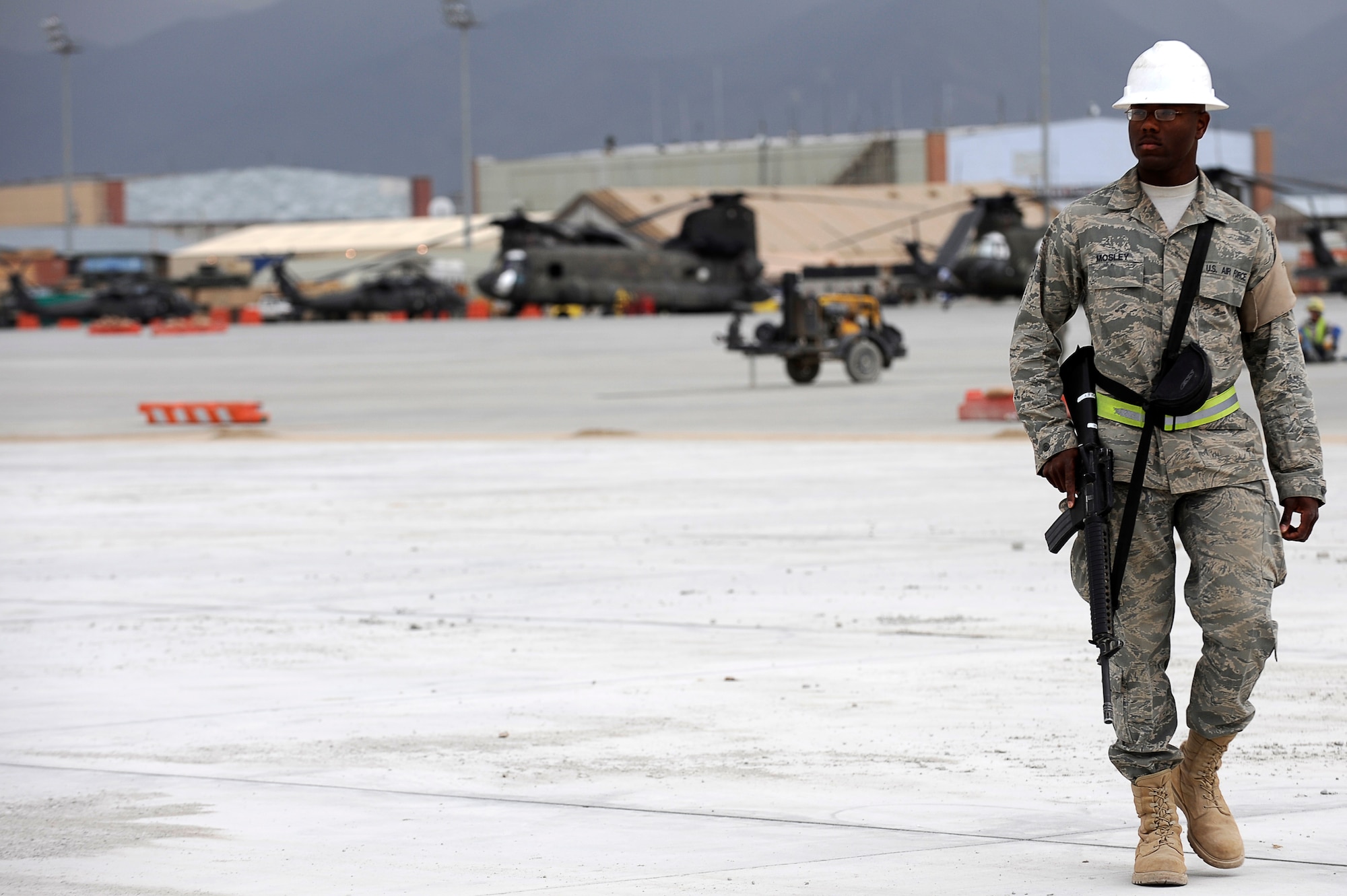 U.S. Air Force Senior Airman Cameron Mosley, 455th Expeditionary Civil Engineer Squadron, provides force protection as contractors perform construction work on a new runway ramp at Bagram Airfield, Afghanistan, May 12, 2010. Airman Mosley is deployed from Ramstein Air Base, Germany, and is from South Haven, Mich. (U.S. Air Force photo by/ Master Sgt. Jeromy K. Cross/released)