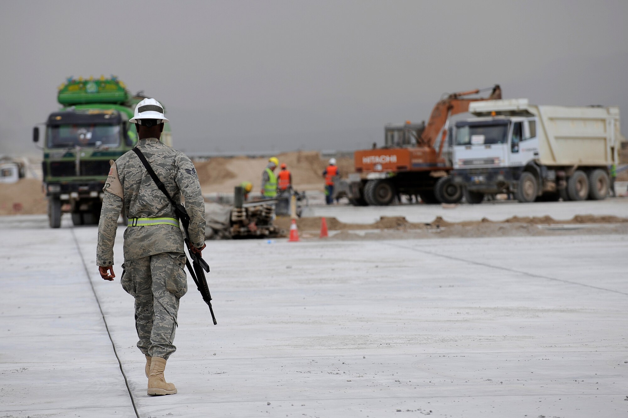 U.S. Air Force Senior Airman Cameron Mosley, 455th Expeditionary Civil Engineer Squadron, provides force protection as contractors perform construction work on a new runway ramp at Bagram Airfield, Afghanistan, May 12, 2010. Airman Mosley is deployed from Ramstein Air Base, Germany, and is from South Haven, Mich. (U.S. Air Force photo by/ Master Sgt. Jeromy K. Cross/released)