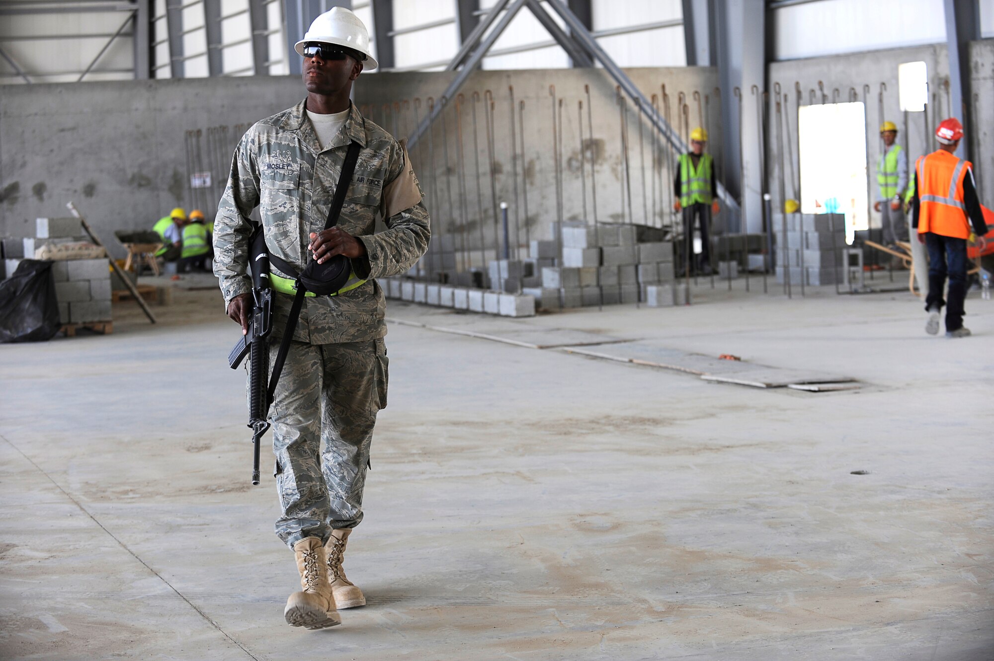 U.S. Air Force Senior Airman Cameron Mosley, 455th Expeditionary Civil Engineer Squadron, provides force protection as contractors perform construction work on a new hangar at Bagram Airfield, Afghanistan, May 12, 2010. Airman Mosley is deployed from Ramstein Air Base, Germany, and is from South Haven, Mich. (U.S. Air Force photo by/ Master Sgt. Jeromy K. Cross/released)