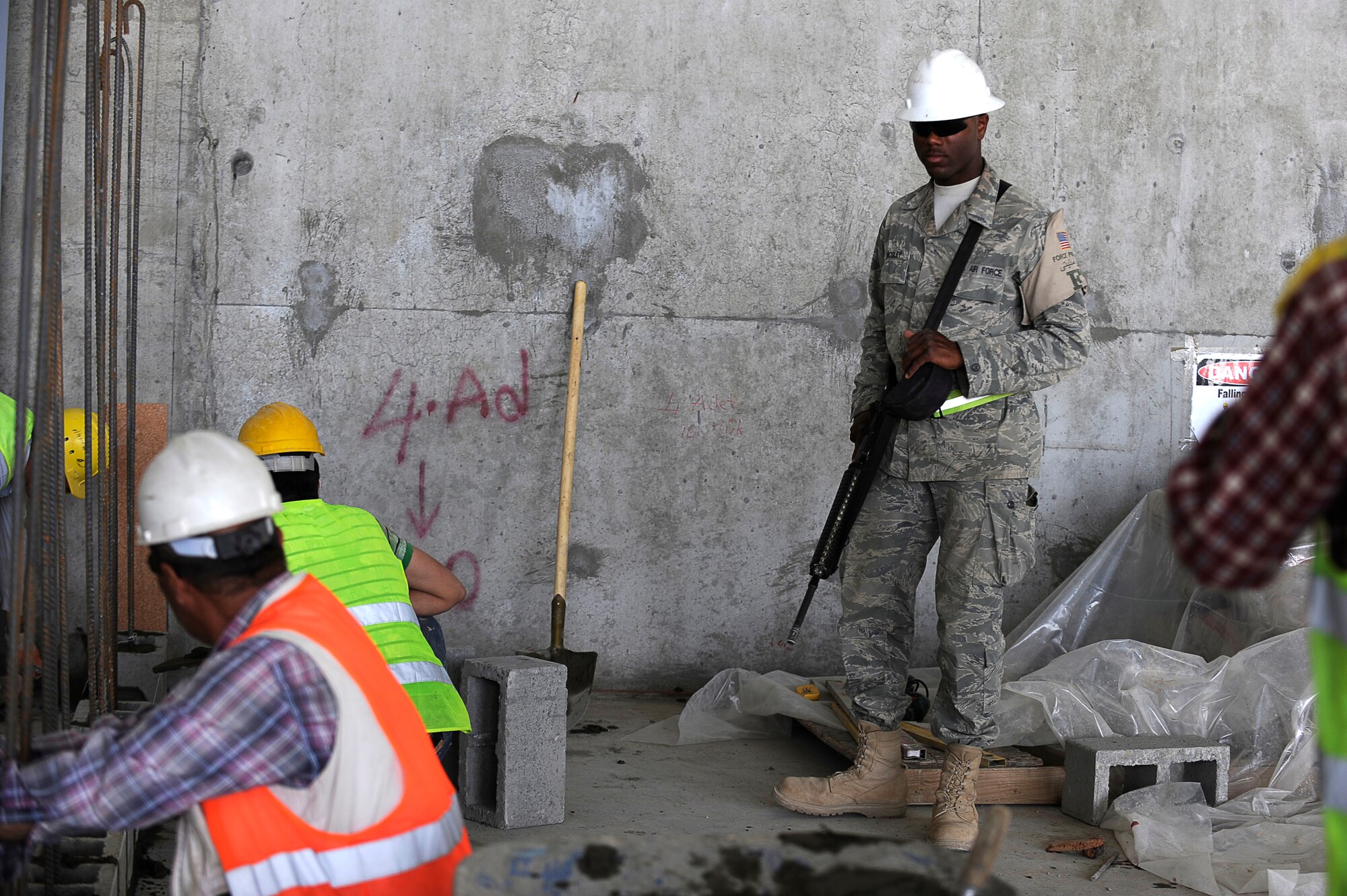 U.S. Air Force Senior Airman Cameron Mosley, 455th Expeditionary Civil Engineer Squadron, provides force protection as contractors perform construction work on a new hangar at Bagram Airfield, Afghanistan, May 12, 2010. Airman Mosley is deployed from Ramstein Air Base, Germany, and is from South Haven, Mich. (U.S. Air Force photo by/ Master Sgt. Jeromy K. Cross/released)