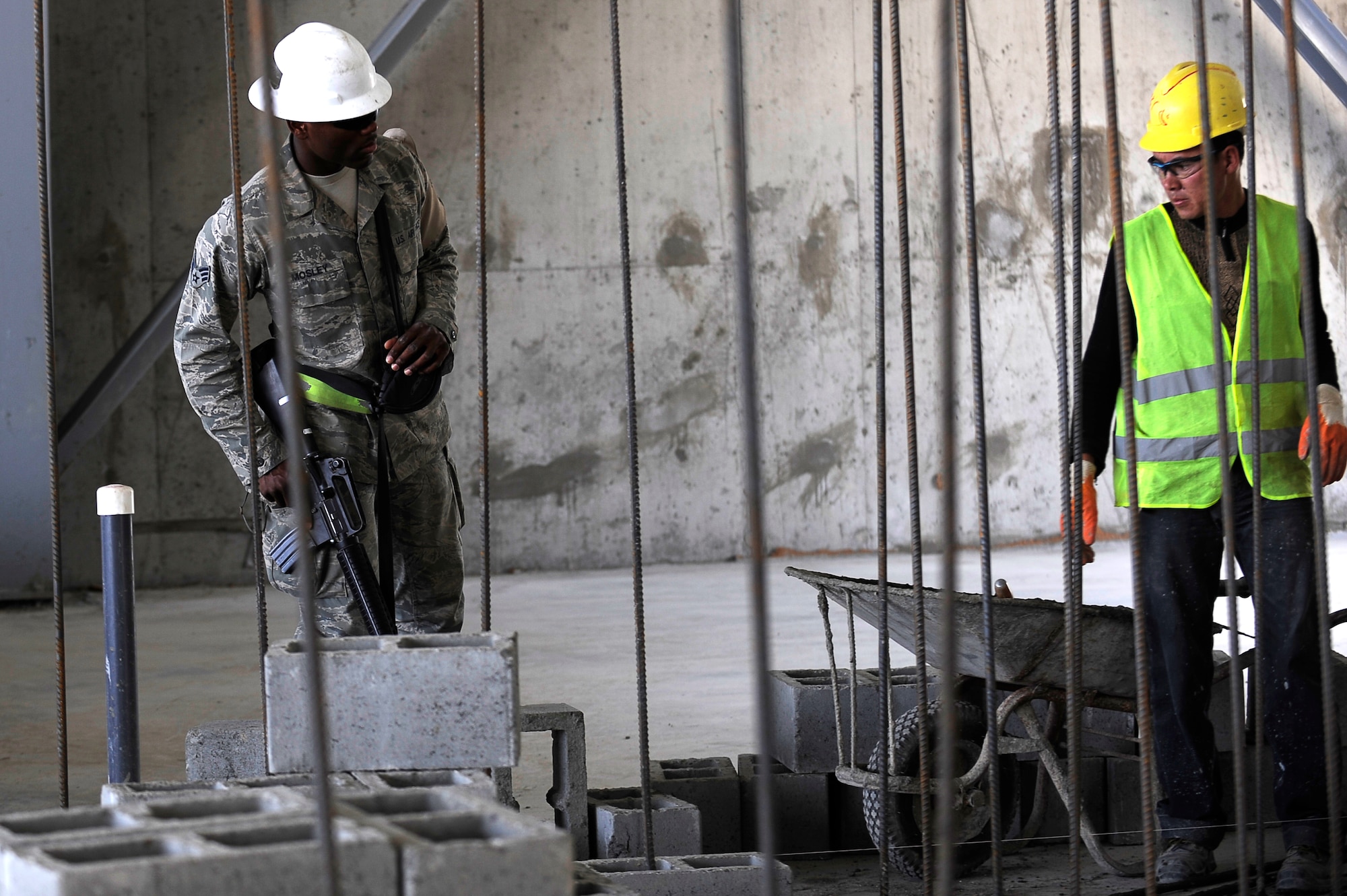 U.S. Air Force Senior Airman Cameron Mosley, 455th Expeditionary Civil Engineer Squadron, provides force protection as contractors perform construction work on a new hangar at Bagram Airfield, Afghanistan, May 12, 2010. Airman Mosley is deployed from Ramstein Air Base, Germany, and is from South Haven, Mich. (U.S. Air Force photo by/ Master Sgt. Jeromy K. Cross/released)