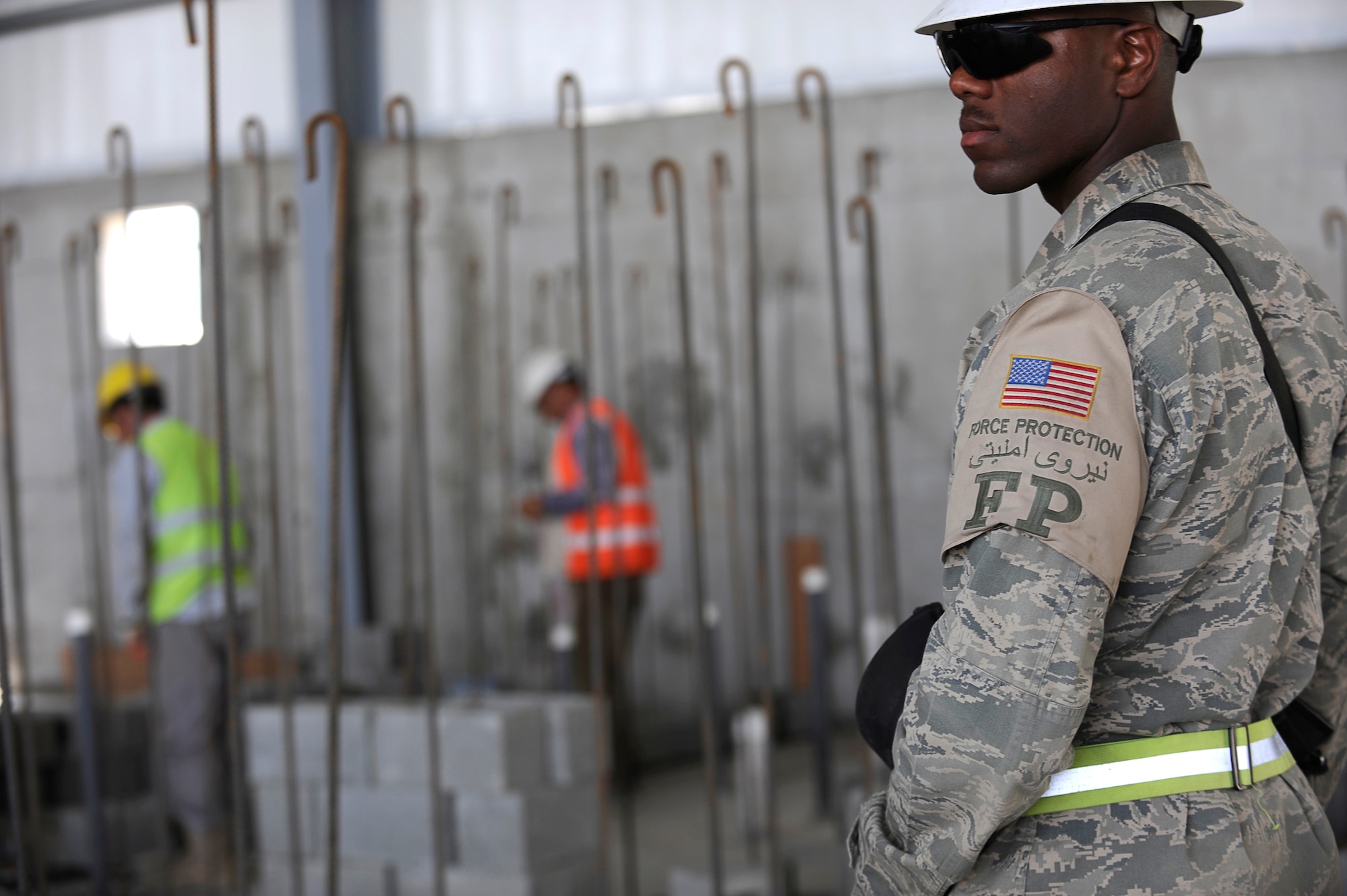U.S. Air Force Senior Airman Cameron Mosley, 455th Expeditionary Civil Engineer Squadron, provides force protection as contractors perform construction work on a new hangar at Bagram Airfield, Afghanistan, May 12, 2010. Airman Mosley is deployed from Ramstein Air Base, Germany, and is from South Haven, Mich. (U.S. Air Force photo by/ Master Sgt. Jeromy K. Cross/released)
