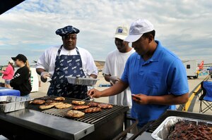 JOINT BASE ANDREWS, Md. - Airman 1st Class Chad Long (right), a public health technician with the 779th Aerospace Medicine Squadron, checks the temperature of chicken during a food booth inspection during the Joint Service Open House here May 16. The public health team had more than 50 airmen from throughout the Air Force District of Washington inspecting every food booth three times a day ensuring food preparers comply with guidelines for sanitation, hygiene and food temperatures. Also pictured are food booth workers Jeffery Stevenson (left) and Senior Airman Greg Armstrong from the Air Force Central Adjudication Facility.(U.S. Air Force photo by Staff Sgt. Renae L. Saylock)