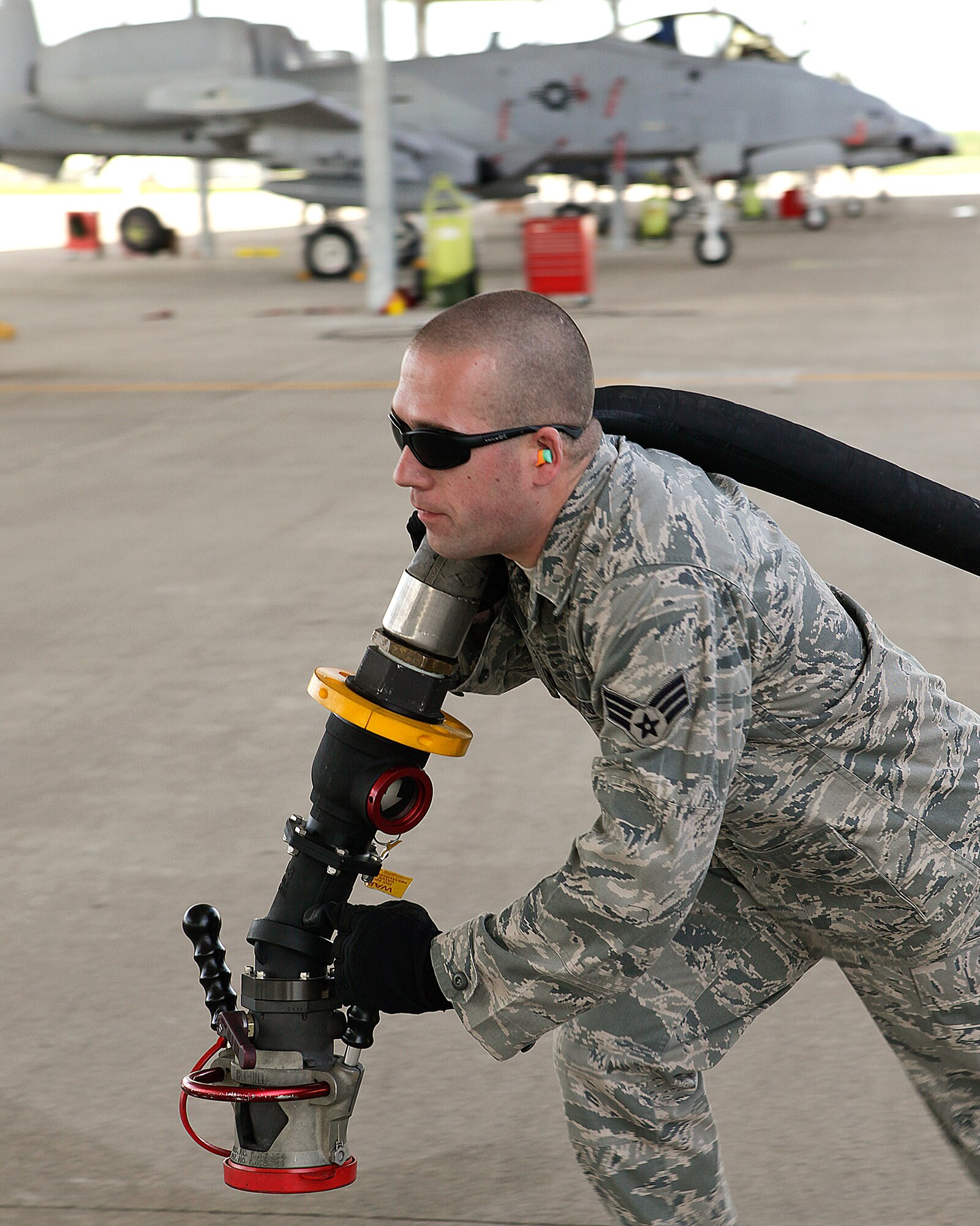 Senior Airman Joseph Fournier pulls the hose out of an R-11 fueling truck to provide JP-8 fuel to an A-10 Thunderbolt II aircraft at Selfridge Air National Guard Base, May 15, 2010. The 127th Logistics Readiness Squadron’s fuels shop provides aviation and ground fuels to a wide variety of military and homeland security customers at the base. (U.S. Air Force photo by Master Sgt. Terry Atwell) (RELEASED)