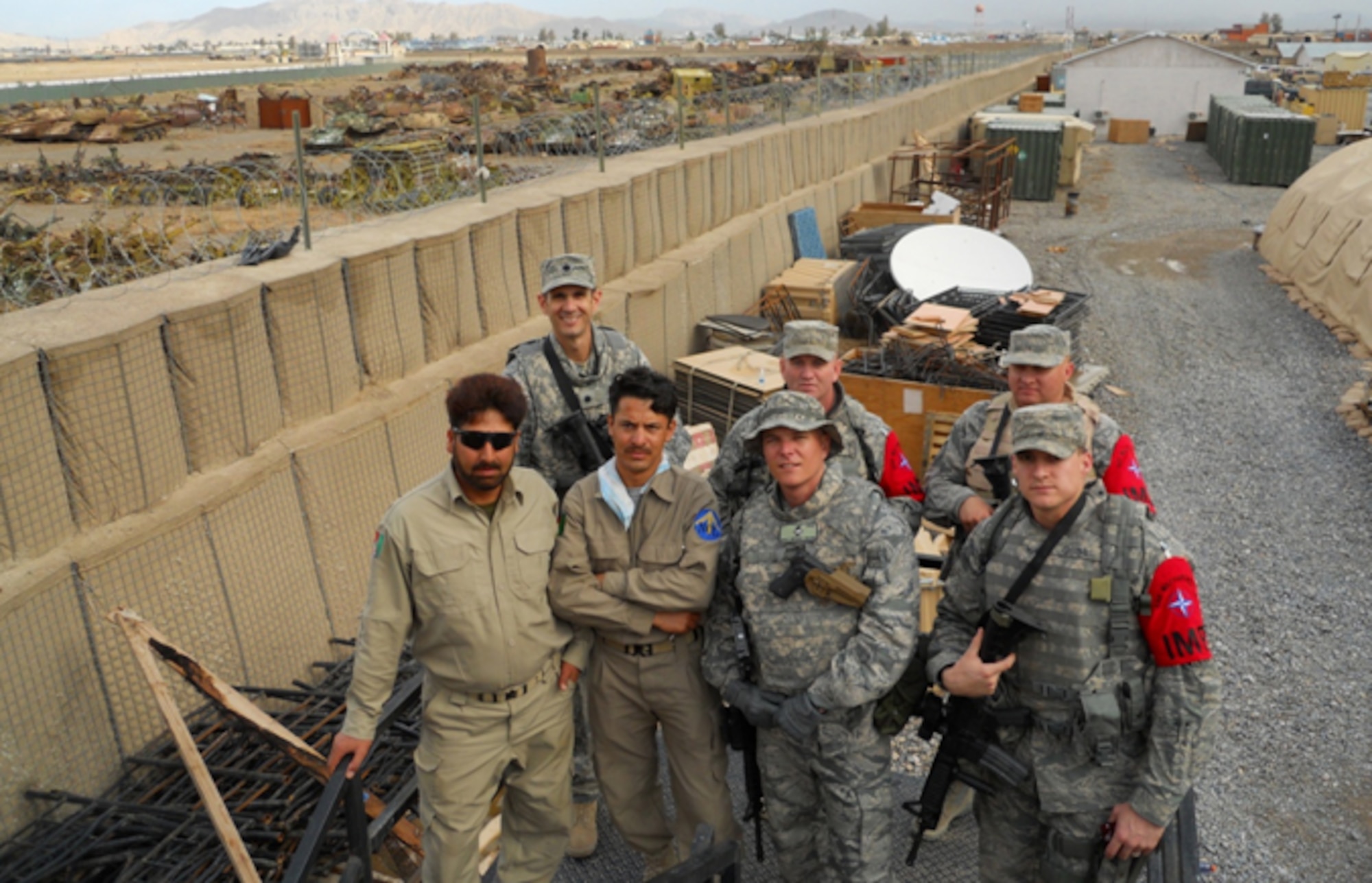 (Back Left) Lt. Col. Joe Rodriguez, 755th Air Expeditionary Squadron commander, and (middle front) Master Sgt. Mike Moore, 755th AES first sergeant, stand with local contract security and 755th AES Airmen assigned to the ISAF Military Police on a show of presence visit to Forward Operating Base Lindsey near Kandahar Airfield, Afghanistan. (Courtesy photo)