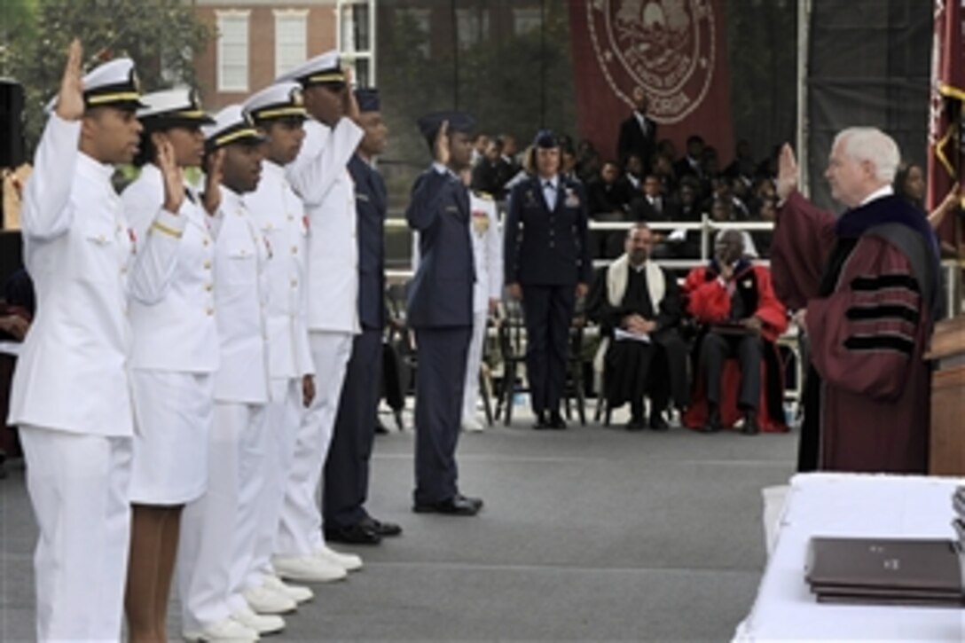 Defense Secretary Robert M. Gates delivers the oath of office to newly commissioned sailors and airmen at  Morehouse College's 126th Commencement ceremony in Atlanta, May 16, 2010. 