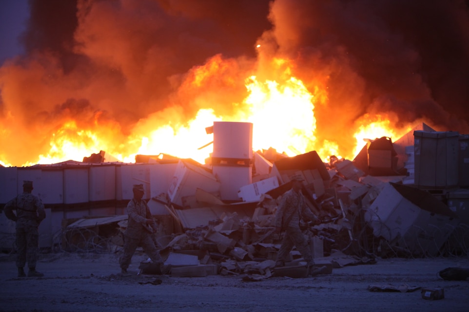 The Supply Management Unit lot here burns, May 16. Marines with Marine Wing Support Squadron 274 fought to contain the fire to save nearby facilities. ::r::::n::