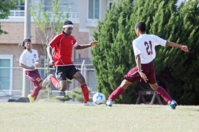 Mikhael Cometa, left-middle position for the Matthew C. Perry High School boys soccer team, attempts to keep Ta’mir Seraphin, team captain and forward position for the EJ King High School boys soccer team, from driving the ball down field during the Department of Defense Dependent Schools Class “A” Far East Soccer Tournament at the M.C. Perry High School Soccer field Sunday.