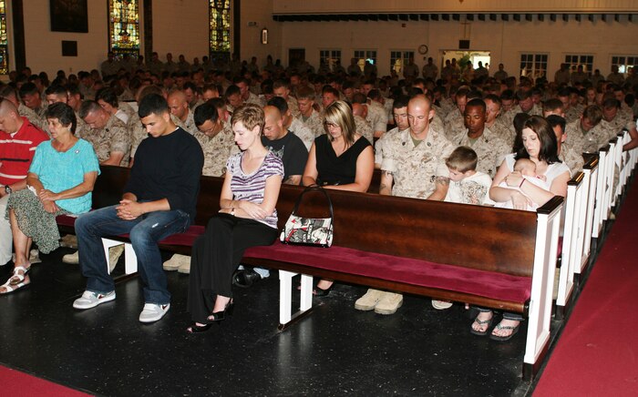 Family, friends, Marines and sailors bow their heads and close their eyes for a moment of silence during a ceremony in the Protestant Chapel aboard Camp Lejeune, N.C., May 17, 2010, to honor five Marines of 2nd Explosive Ordnance Disposal Company, 8th Engineer Support Battalion, 2nd Marine Logistics Group, who gave their lives while deployed to Iraq and Afghanistan in support of Operations Iraqi and Enduring Freedom from February 2008 to February 2010. Marines took turns speaking on behalf of the fallen Marines as the many family members, friends and service members listened to stories and experiences that were shared amongst the Marines of 2nd EOD Co.